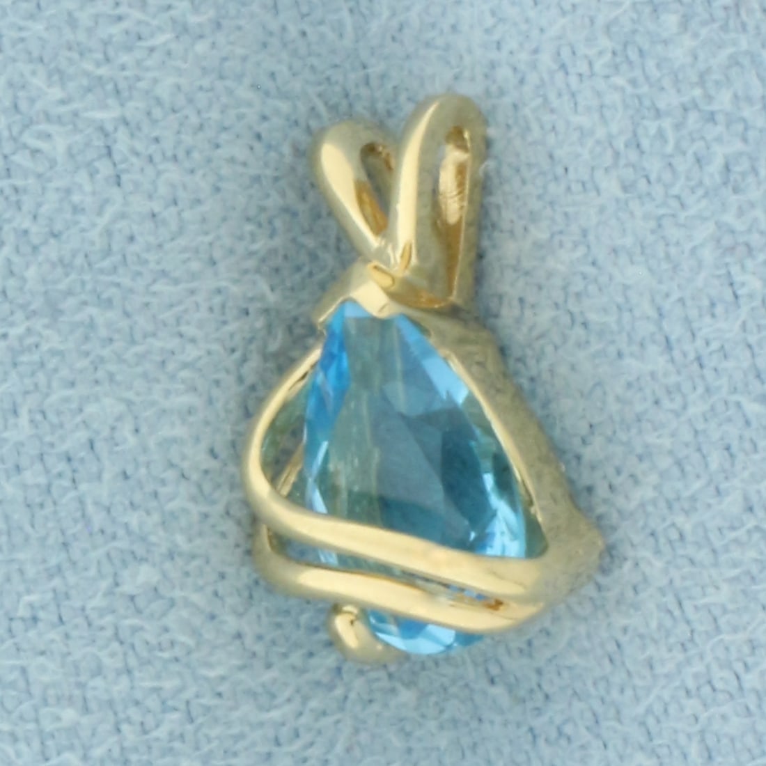 Swiss Blue Topaz Pendant in 14k Yellow Gold: In 14k yellow gold. Measures 1/2 inch x 1/4 inch. Contains 19x6mm high quality natural Swiss Blue Topa gemstone, approximately 2 carats, with electric blue color and excellent clarity. 1.1g.