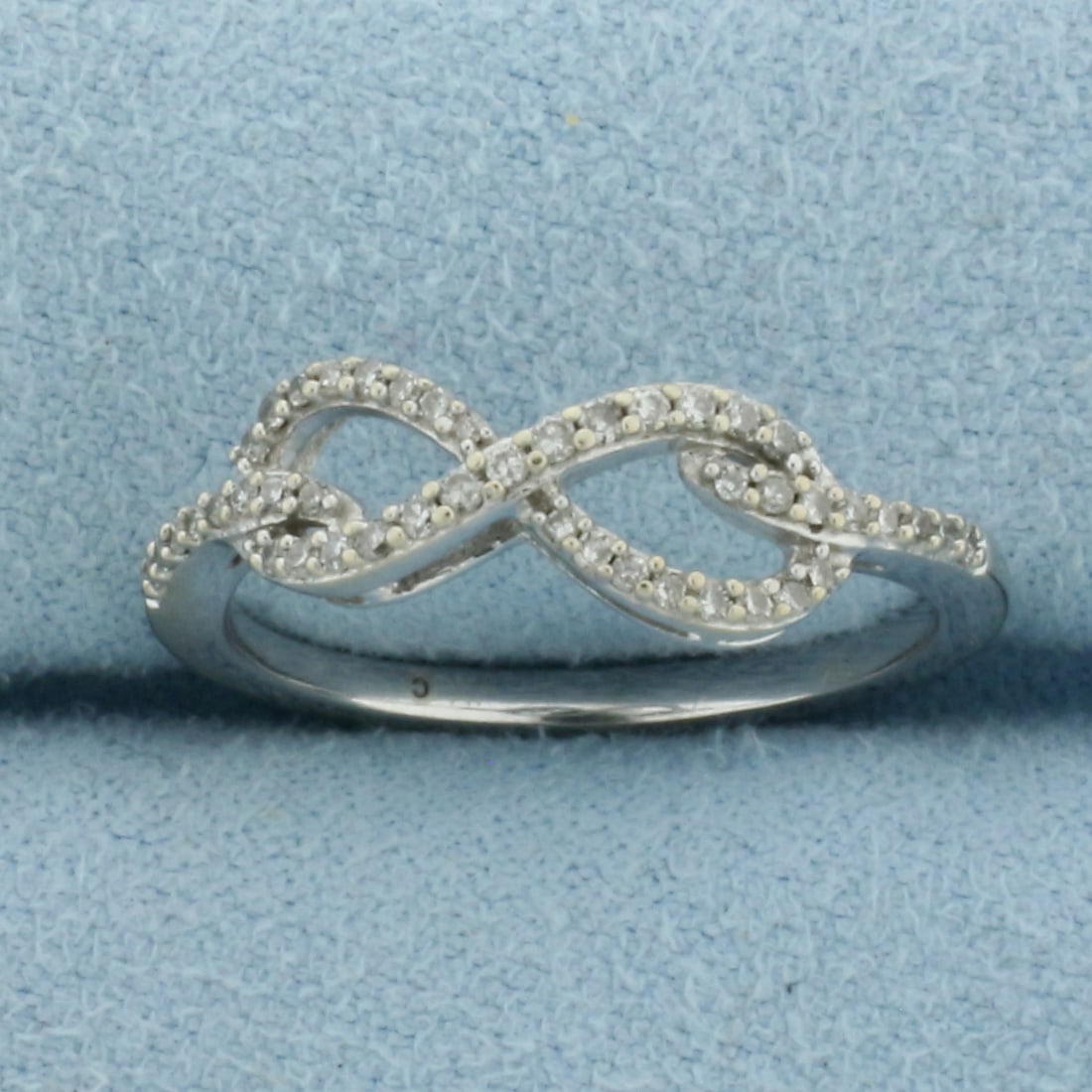 Diamond Infinity Knot Ring in 10k White Gold: In 10k White Gold. Contains forty-five high quality 1/2pt diamonds. 5.7mm wide. Size 7. 2.1g.