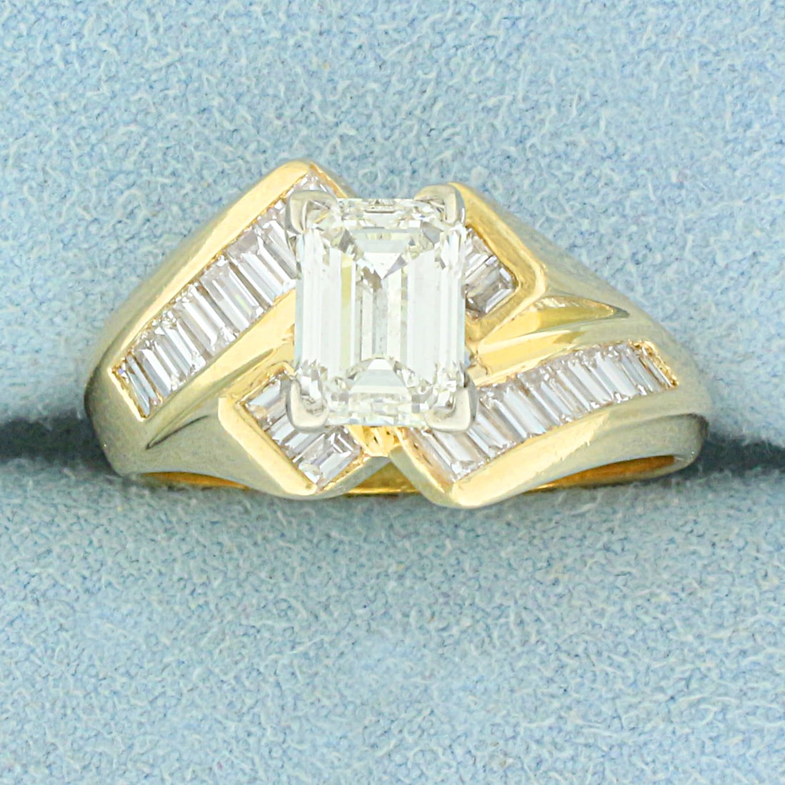 EGL Certified 2ct TW Emerald Cut and Baguette Diamond Bypass Engagement Ring in 14K Yellow Gold: In 14K Yellow Gold. Contains one high quality EGL USA Certified 1.45ct Emerald Cut Diamond, VS1 Clarity/L color. Also contains twenty two high quality 2x1mm baguette cut Diamonds, .55ct TW, VS clarity