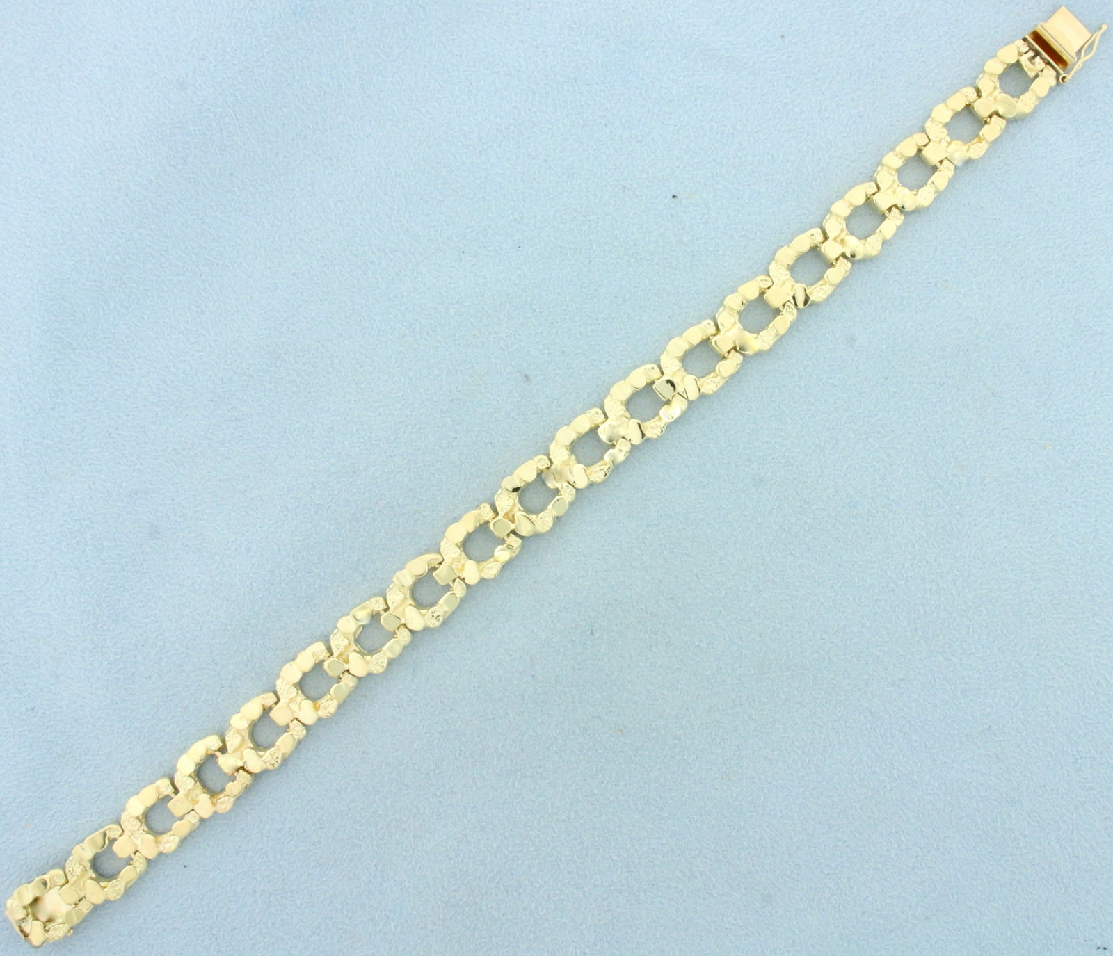 Nugget Horseshoe Link Bracelet in 14K Yellow Gold: In 14K Yellow Gold. 8 inches long, 10.3mm wide. Safety clasp. 32.9g.