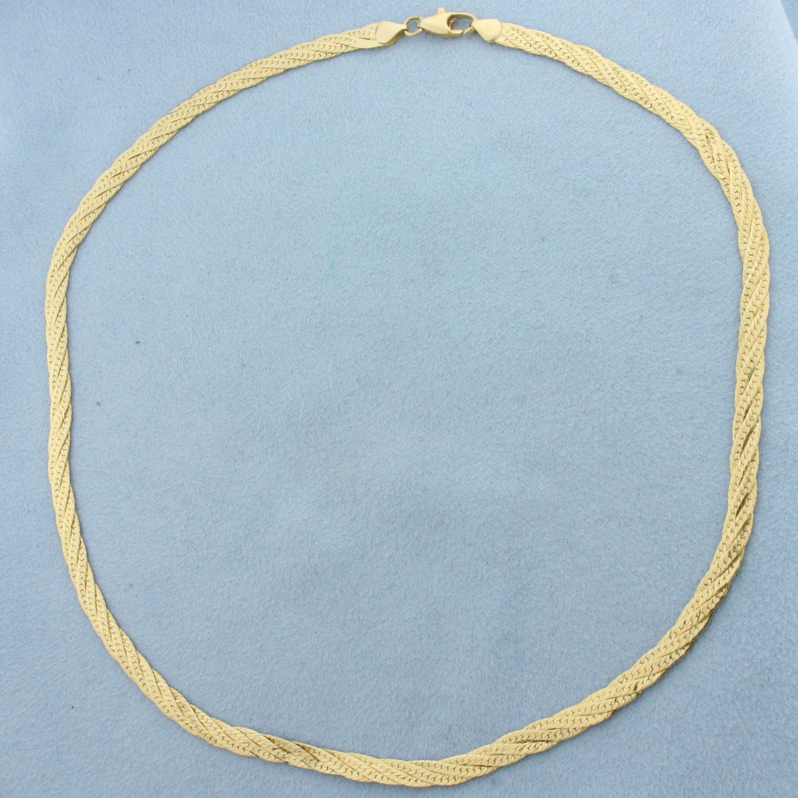 16 Inch Braided Herringbone Link Choker Necklace in 14k Yellow Gold: In 14k yellow gold. Italian made. 16 inches long, 4mm wide. Lobster clasp. 10.9g.