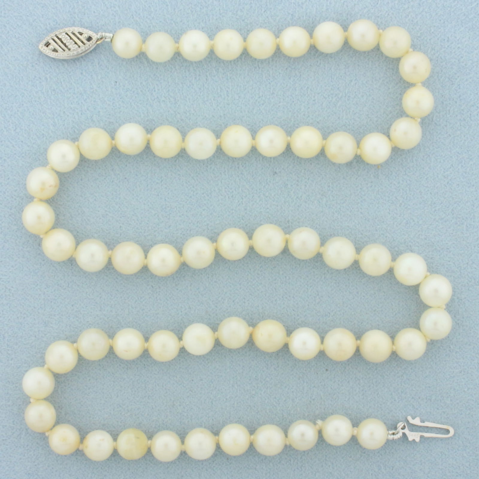 Vintage Pearl Strand Necklace in 14k White Gold: 14k white gold clasp. 15.5 inches long. Hand knotted 5.4 to 5.8mm high quality cultured pearls with high luster. Decorative filigree locking clasp. 16.8g.