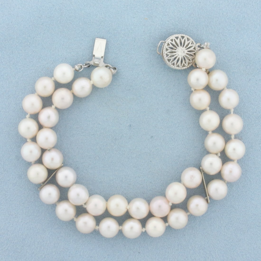 Akoya Pearl Double Strand Bracelet in 14k White Gold: In 14k White Gold. Contains 40 7.5mm high quality Cultured Akoya Pearls with high luster. 7 1/4 inches long. 1/2 inch wide. Hand knotted. Filigree locking clasp. 24.1g.