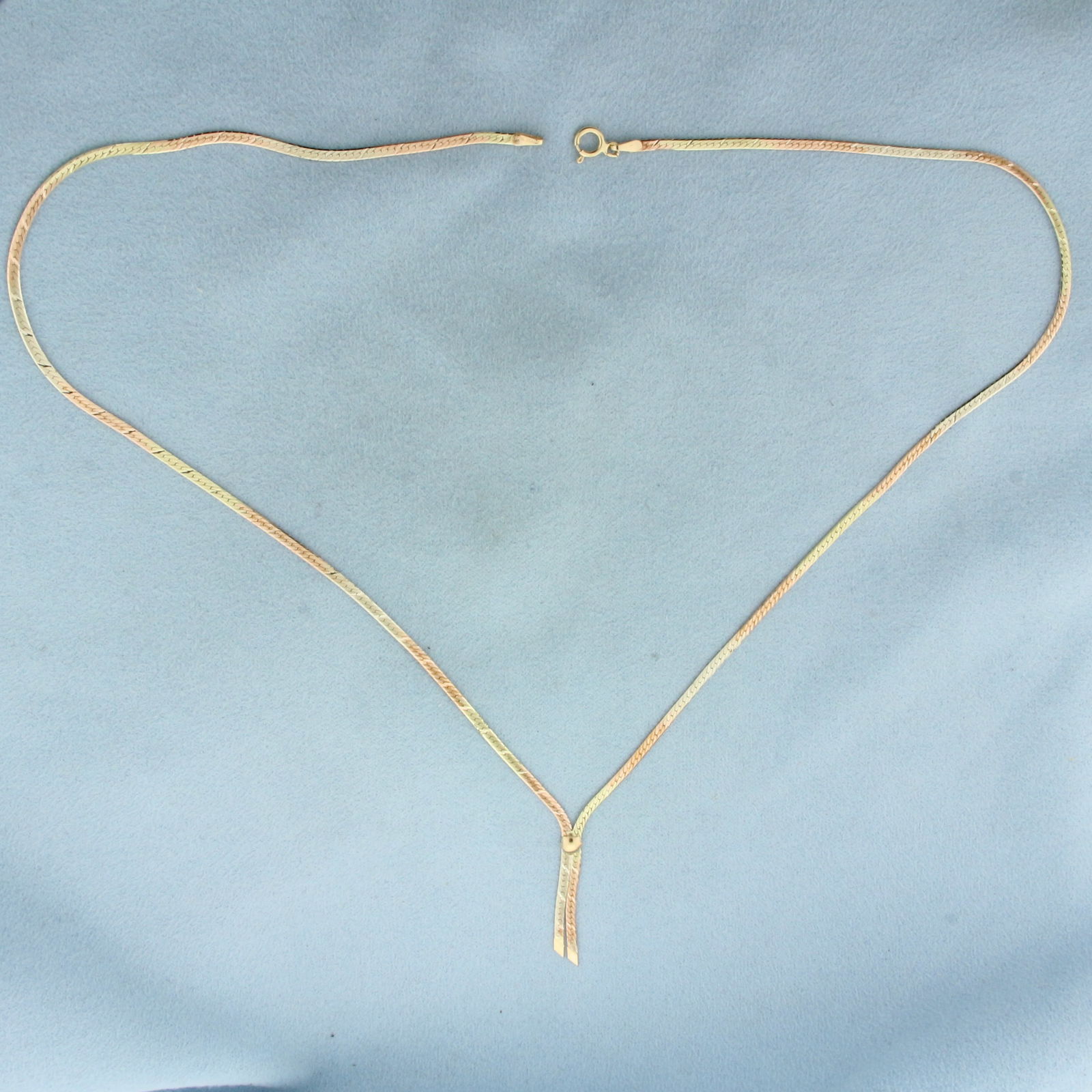 Italian Tri-Color Diamond Cut Herringbone Necklace in 14k Yellow, Rose, and White Gold: In 14k Yellow, Rose, and White Gold. 18 inches long. 1.8mm wide. Italian made. Diamond cut diagonal stripes for added brilliance. Spring clasp. 4.1g.