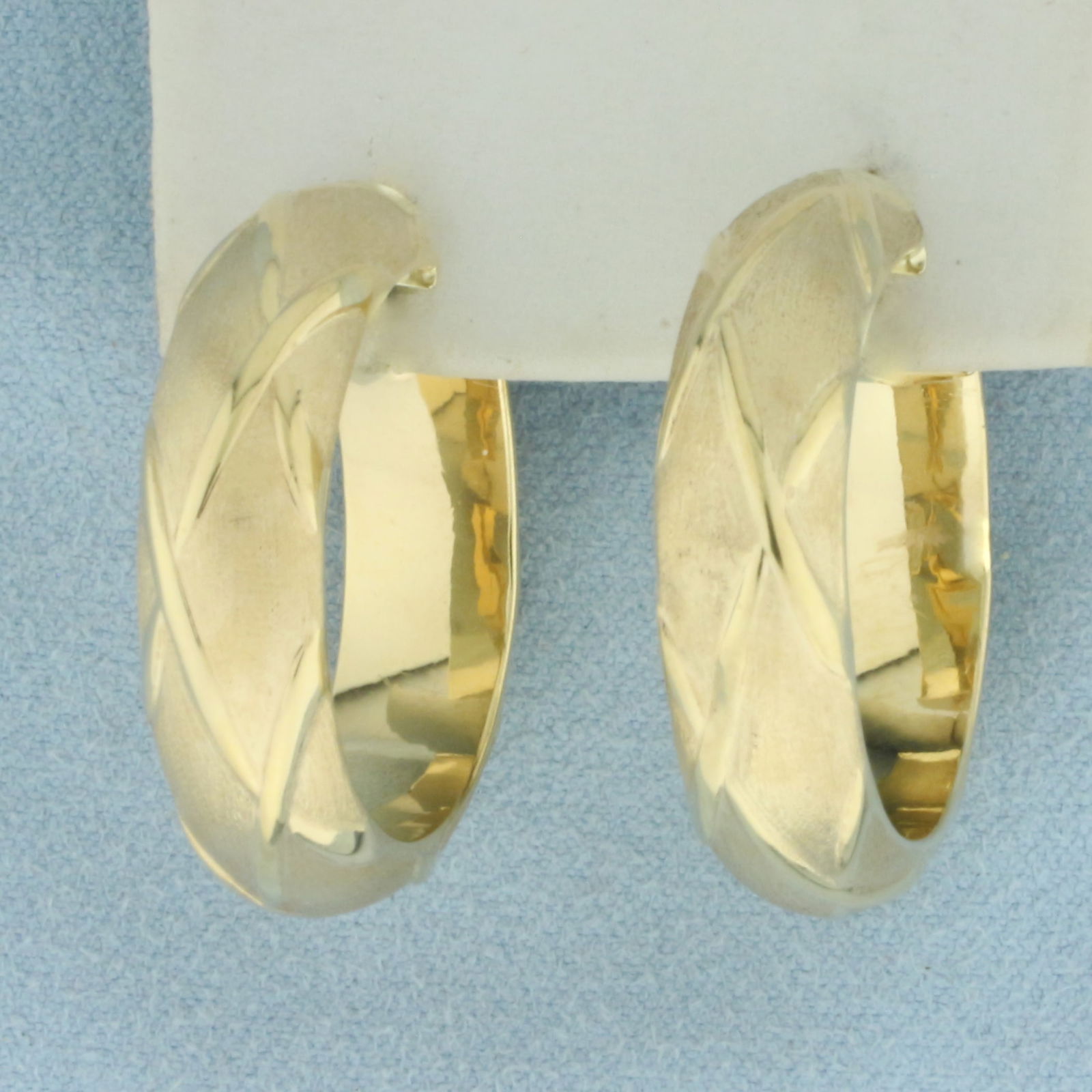 Italian Satin and High Polish Quilted Hoop Earrings in 14k Yellow Gold: In 14k Yellow Gold. 1 1/4 inches long. 8mm wide. Small indentation on bottom of one earring, not noticeable. Italian made. 5.7g.