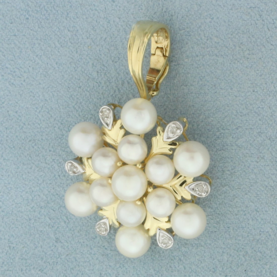 Cultured Akoya Pearl and Diamond Pendant in 14k Yellow Gold: In 14k Yellow Gold. Contains seven 5.5mm and six 5mm high quality Cultured Akoya Pearls with high luster. Also contains six high quality 1/2pt diamonds. 1 3/8 inch long including bale. 1 inch wide.