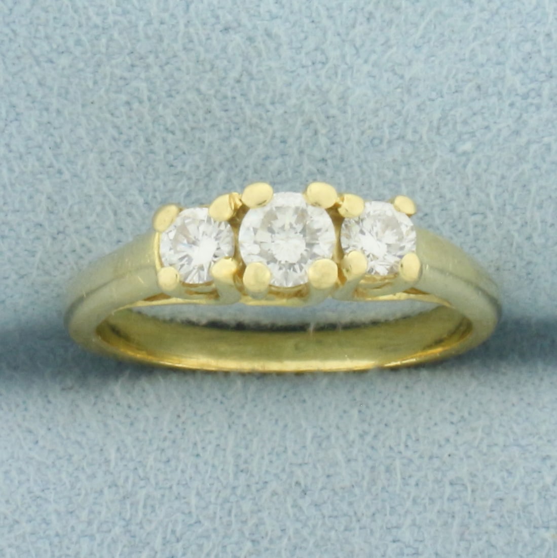 Three Stone Diamond Wedding or Anniversary Ring in 18k Yellow Gold: In 18k Yellow Gold. Contains one 1/4ct and two 1/8ct high quality diamonds, SI clarity/G color. Size 6.5. 3.9g.
