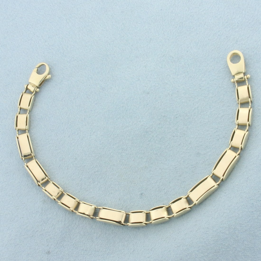 Italian Tank Track Bracelet in 14k Yellow Gold: In 14k Yellow Gold. 6 3/4 inches long. 5.4mm wide. Italian made. Lobster clasp. 8.8g.