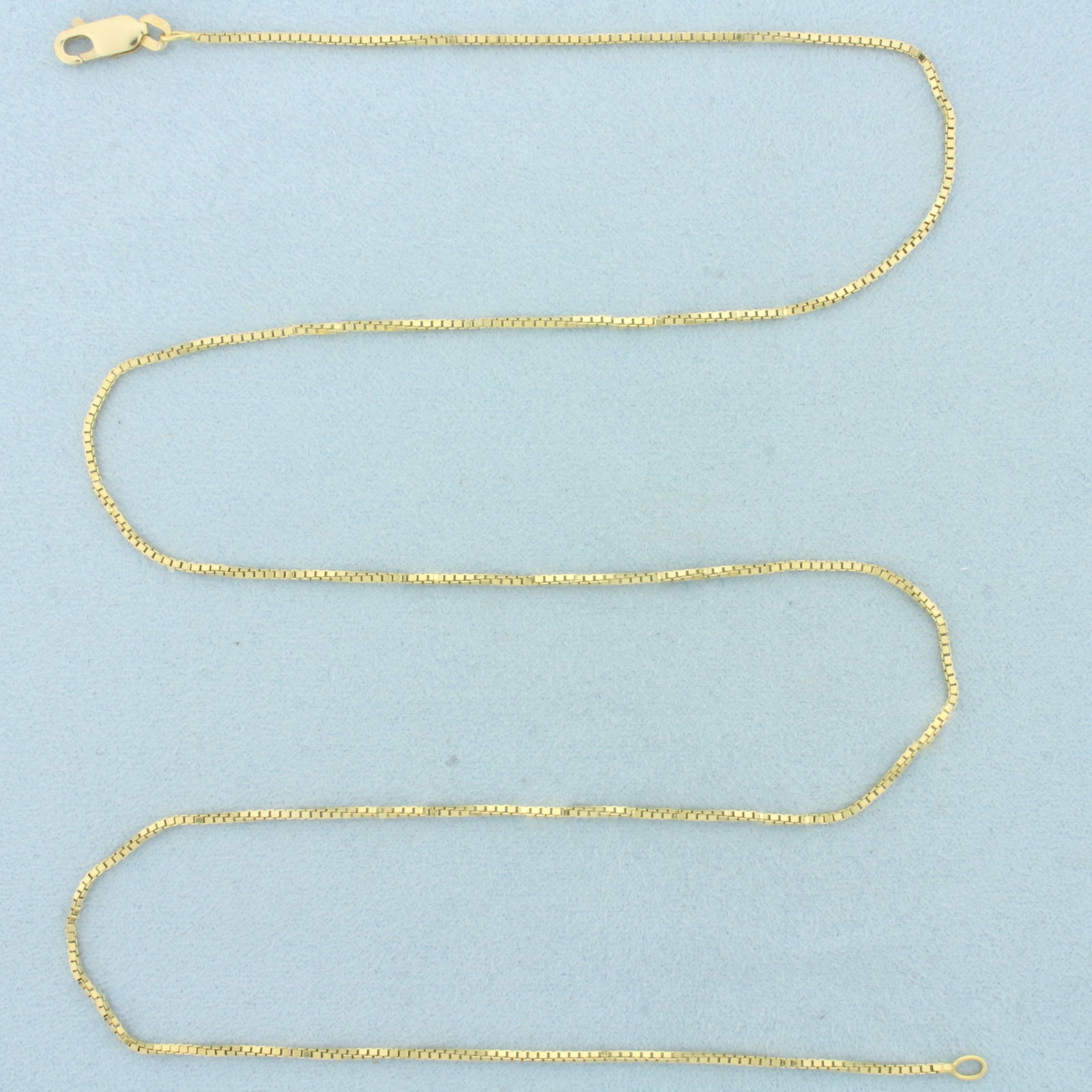24 Inch Box Link Chain Necklace in 18k Yellow Gold: In 18k Yellow Gold. 24 inches long. 1.7mm wide. Box link. Lobster clasp. 7.9g.
