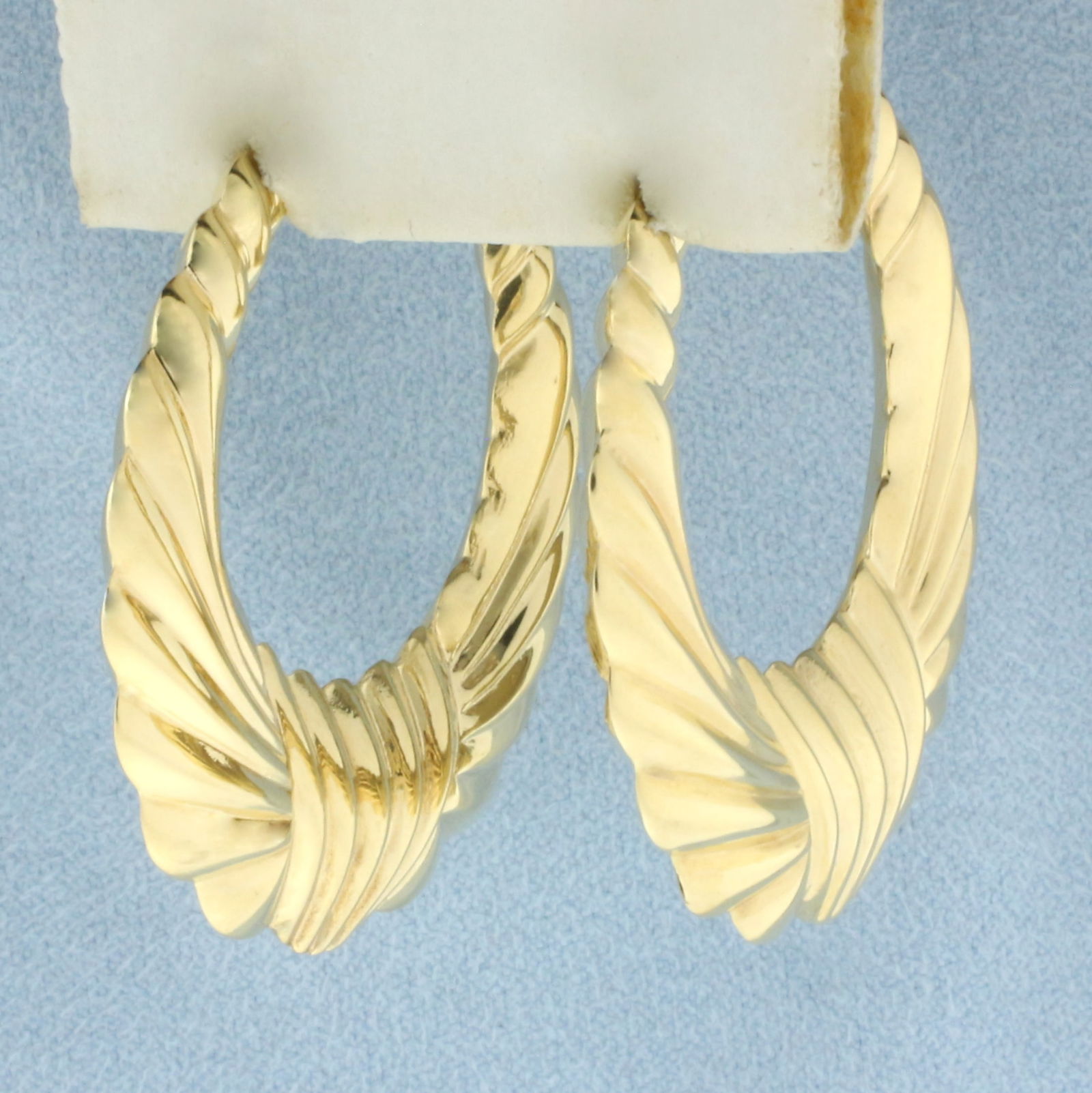 Large Scallop Design Hoop Earrings in 14k Yellow Gold: In 14k Yellow Gold. 1 1/2 inch long. 1 3/8 inch wide. Leverbacks. 6.1g.