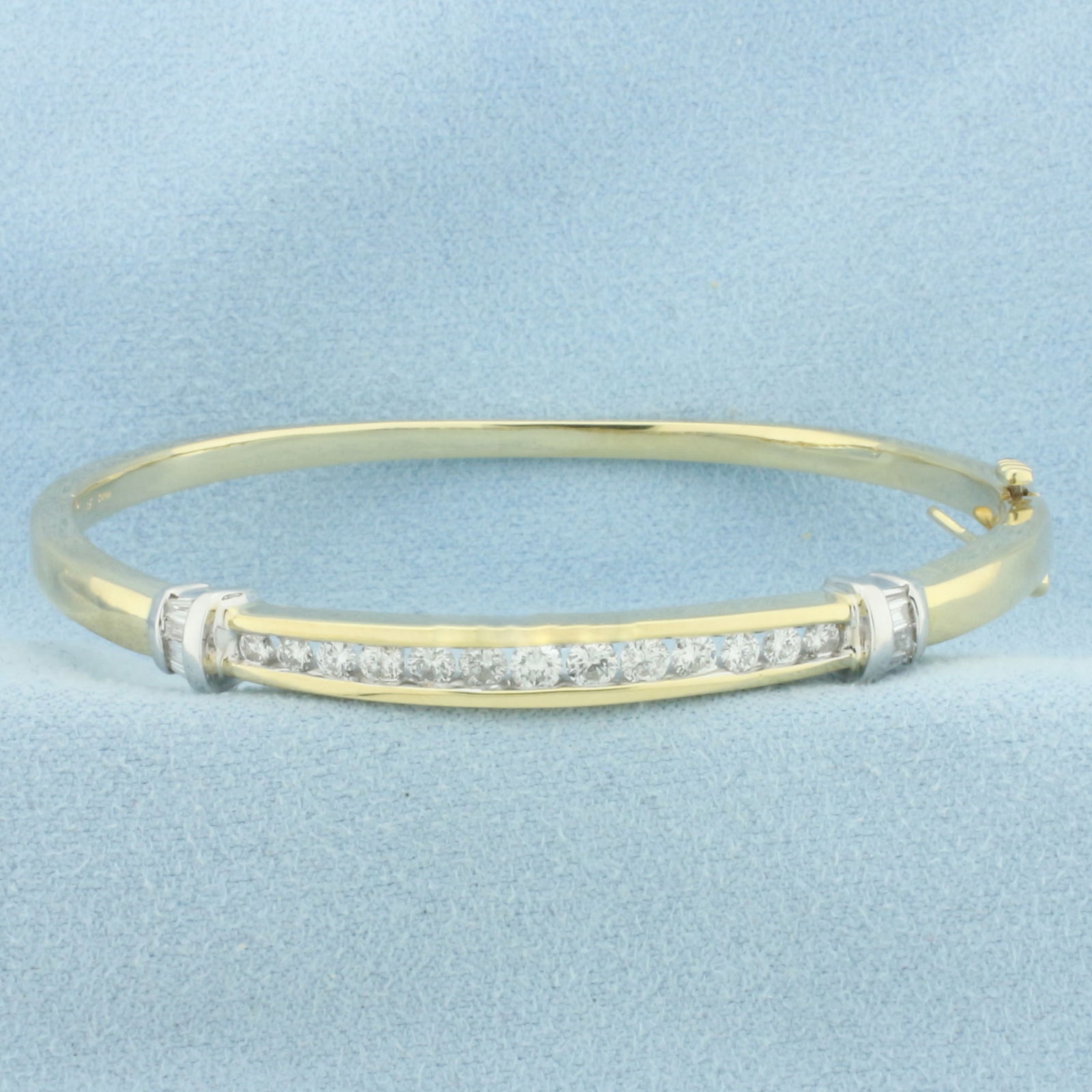 Two Tone Diamond Bangle Bracelet in 14K Yellow and White Gold: In 14k yellow and white gold. Hinged style for easy on/off. Interior dimensions: 2.25 inches x 2 inches. Contains 13 round and 8 baguette high quality diamonds, 1ct TW, SI clarity/H color. Slide clasp