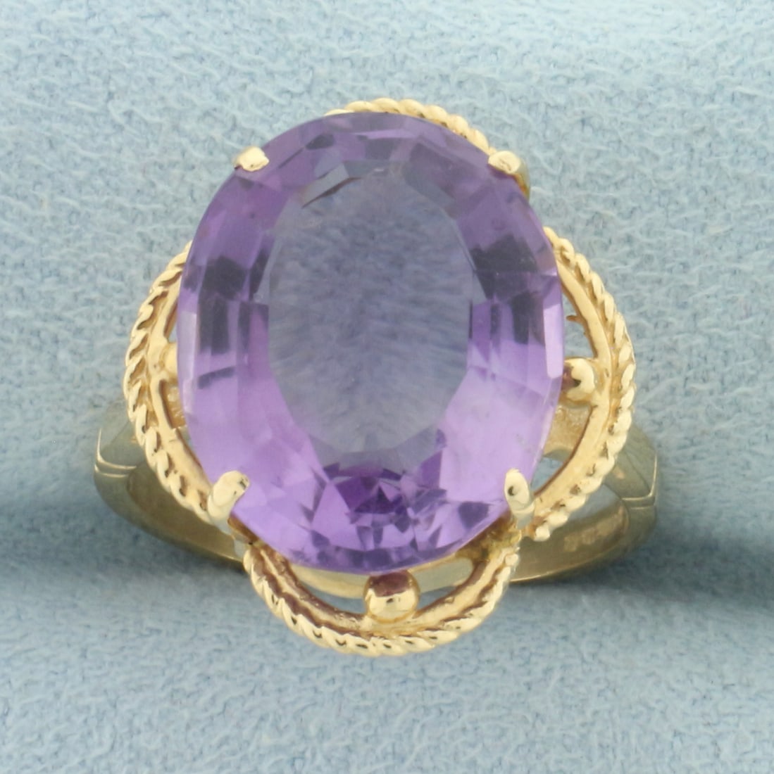 8ct Fancy Step Cut Amethyst Gemstone Statement Ring in 14k Yellow Gold: In 14k yellow gold. Contains one high quality natural fancy oval step cut amethyst gemstone with bright color and excellent clarity. Size: 6.5. 5.4g.