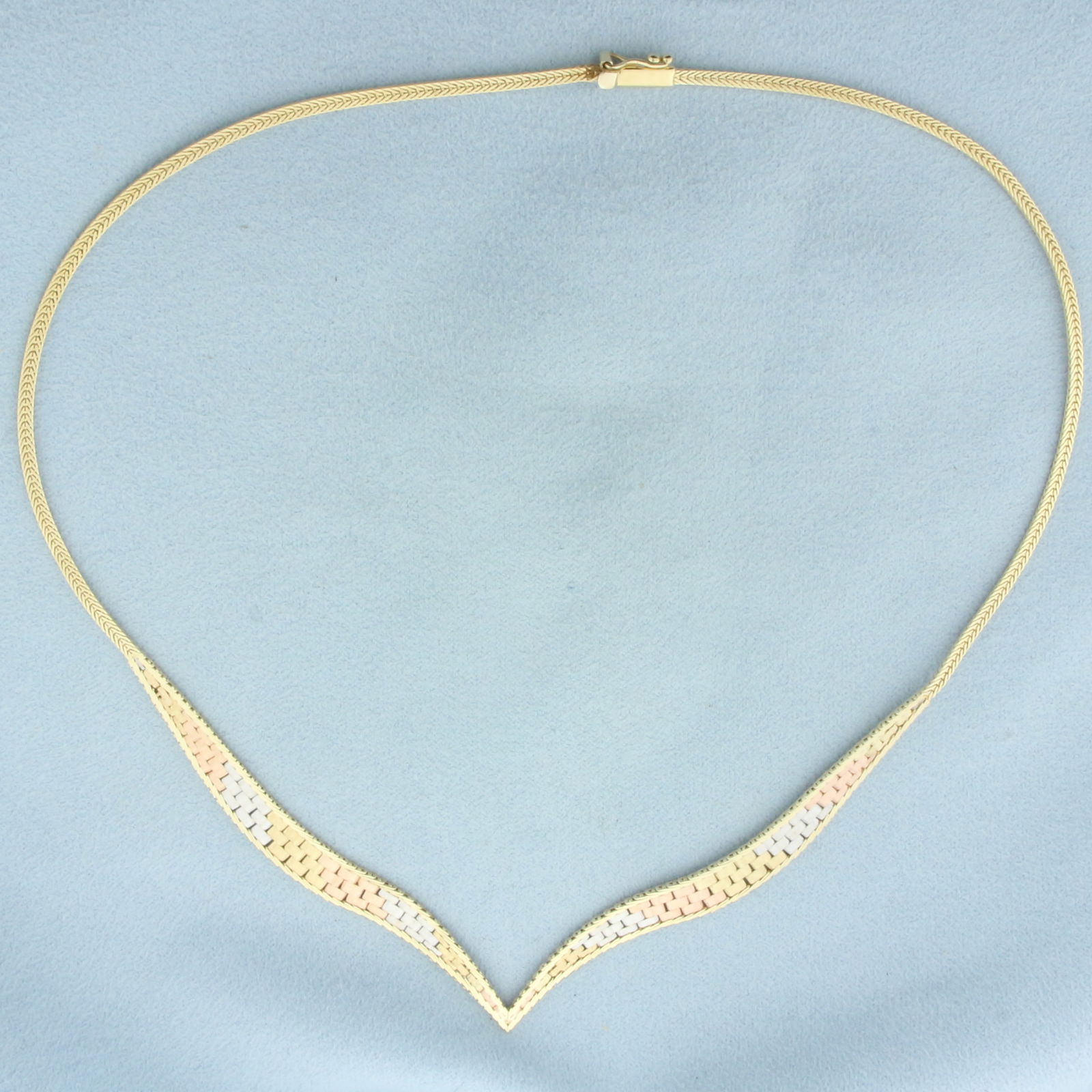 Tri-Color Italian V Necklace in 14k Yellow, White, and Rose Gold: In 14k Yellow, White, and Rose Gold. 16 inches long. 6.6mm wide at widest part of chain. Italian made. Slide clasp with safety latch. 10.6g.