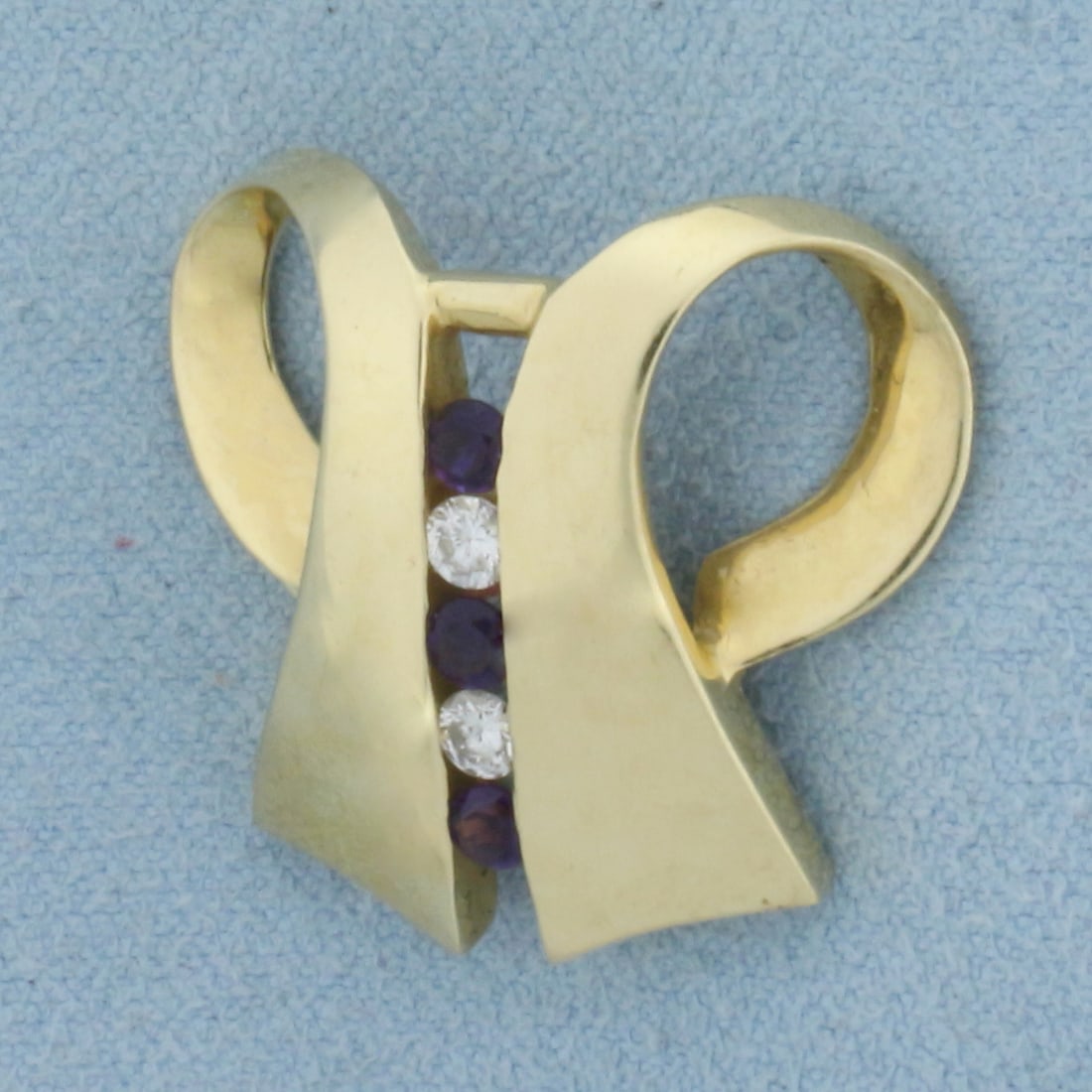 Designer Diamond and Amethyst Pendant or Slide in 14K Yellow Gold: In 14K Yellow Gold. Contains two .1ct high quality diamonds, SI clarity/H color. Also contains three high quality 1/10ct Amethyst gemstones with bright purple color and excellent clarity. 1/2ct TW of