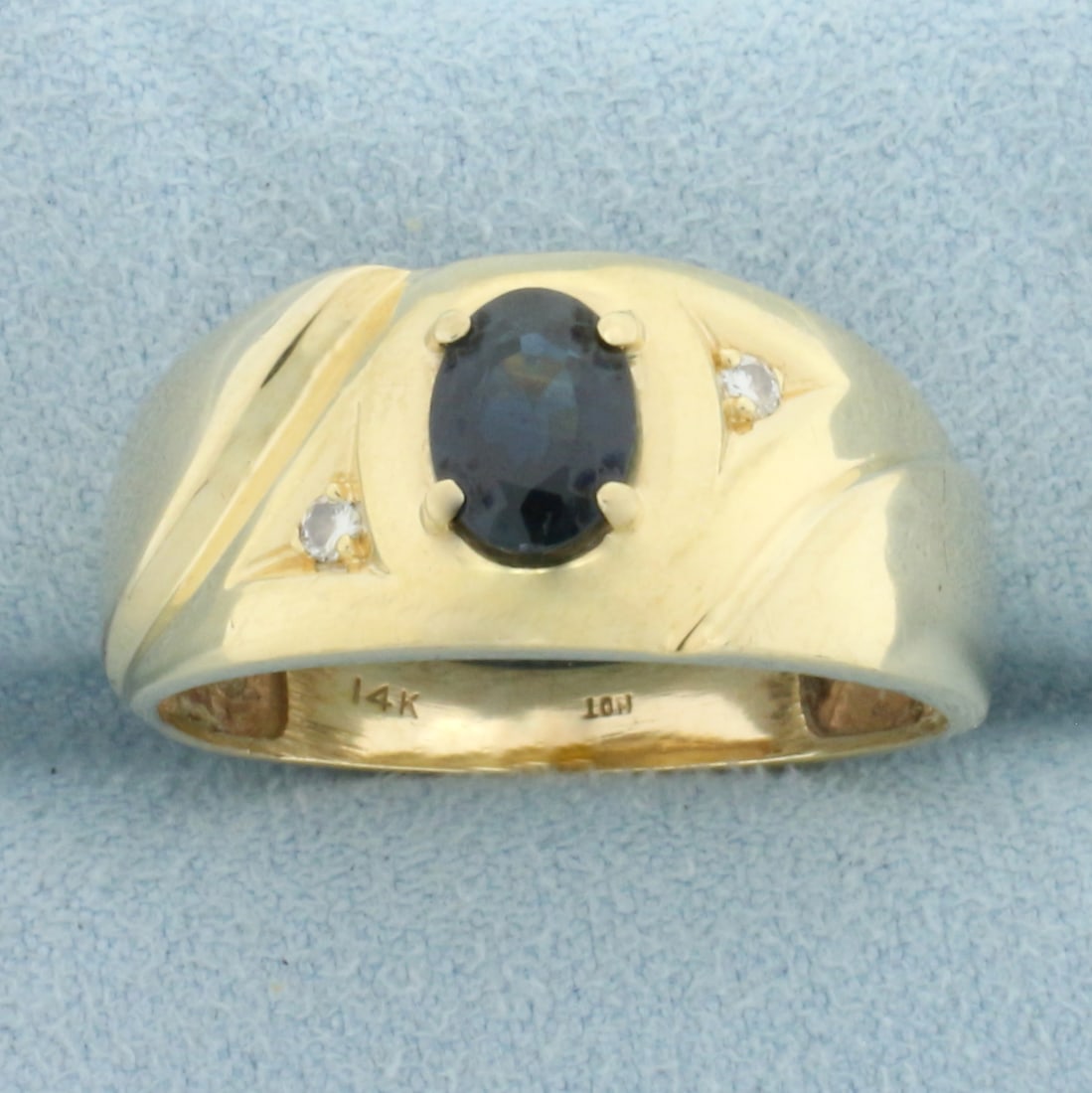 Sapphire and Diamond Ring in 14k Yellow Gold: In 14k Yellow Gold. Contains one high quality natural 7mmx5mm Sapphire gemstone, approximately 1ct, with intense color and excellent clarity. Also contains two high quality .02ct diamonds, VS