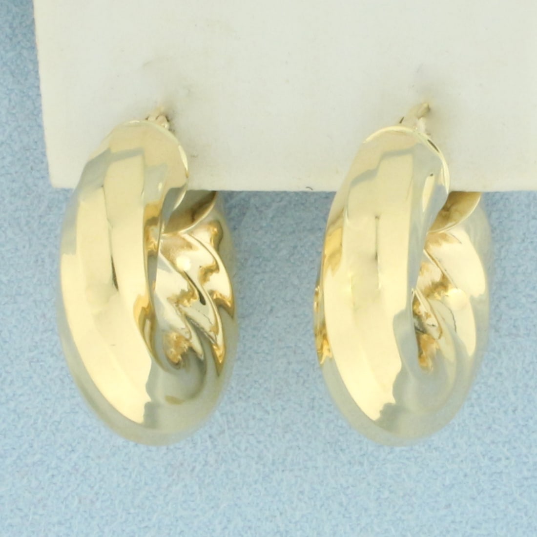 Italian Twisting Wide Hoop Earrings in 14k Yellow Gold: In 14k Yellow Gold. 1 inch long. 1 inch wide. 7.6mm thick. 5.7g.