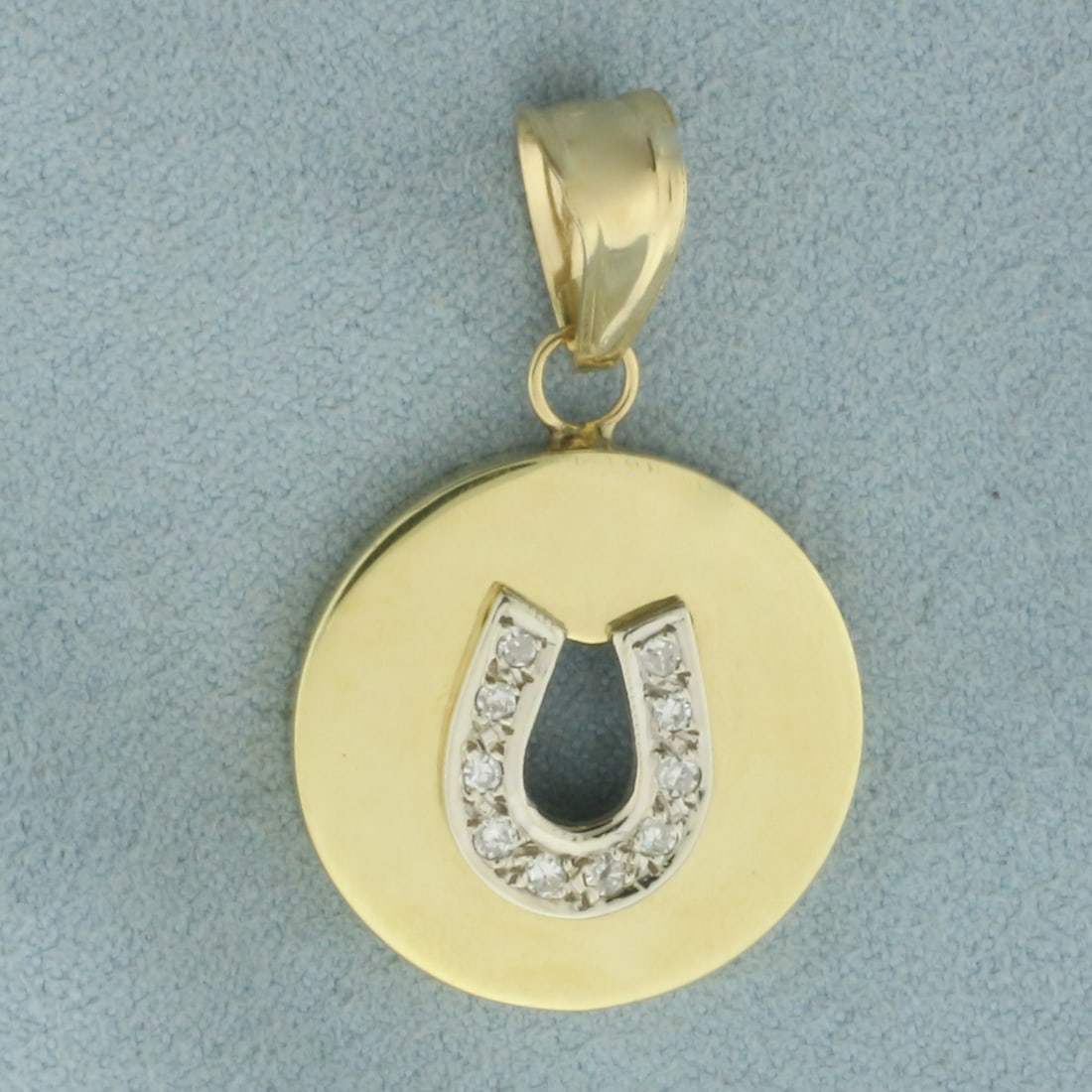 Diamond Horseshoe Pendant in 14k Yellow Gold: In 14k Yellow Gold. Contains ten high quality diamonds, 1/8ct TW, SI clarity/H color. 1 3/8 inch long. 3/4 inch wide. 4.6g.