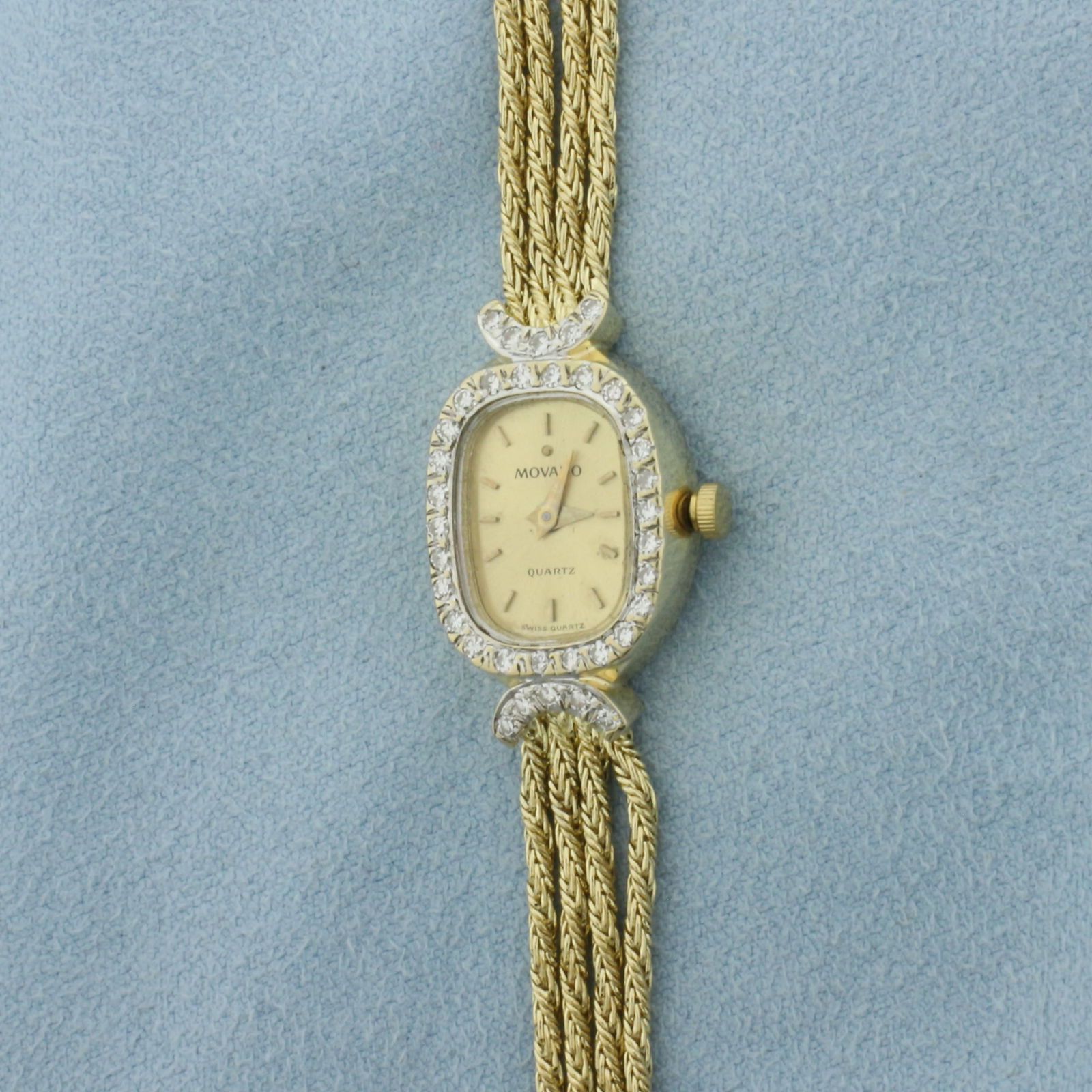 Vintage Movado Diamond Rope Bracelet Watch in Solid 14k Yellow Gold: Case and bracelet in solid 14k yellow gold. 7 inches long. Case is 20mm long by 15mm wid. Contains .43ct TW of high quality diamonds in bezel.. Quartz movement runs great, new battery. Stamped D43, 79