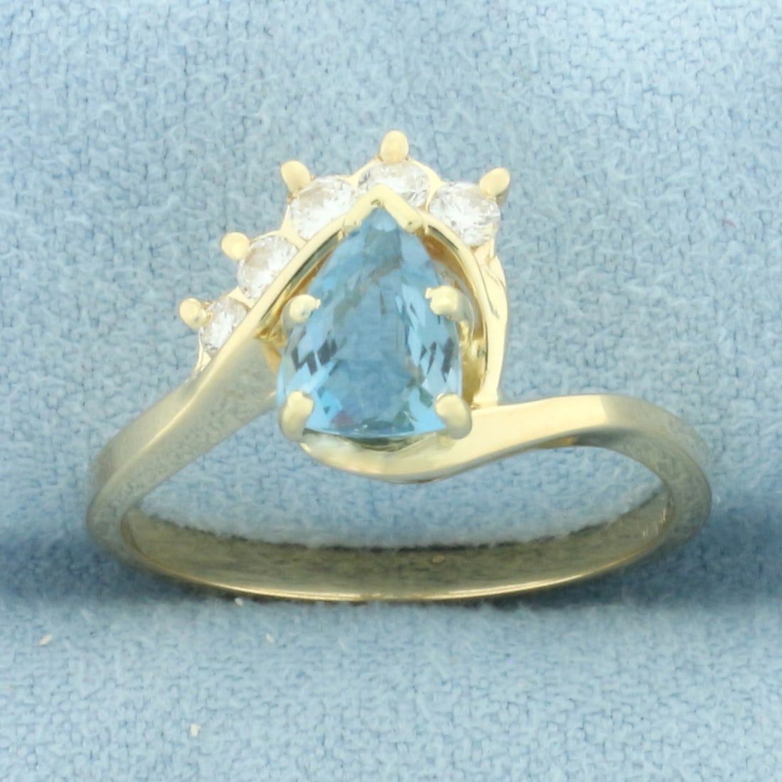 Aquamarine and Diamond Ring in 14k Yellow Gold: In 14k yellow gold. Contains one high quality natural 6mm by 4mm pear shaped Aquamarine gemstone with intense color and excellent clarity Also contains five high quality diamonds, 1/5ct TW, VS clarity