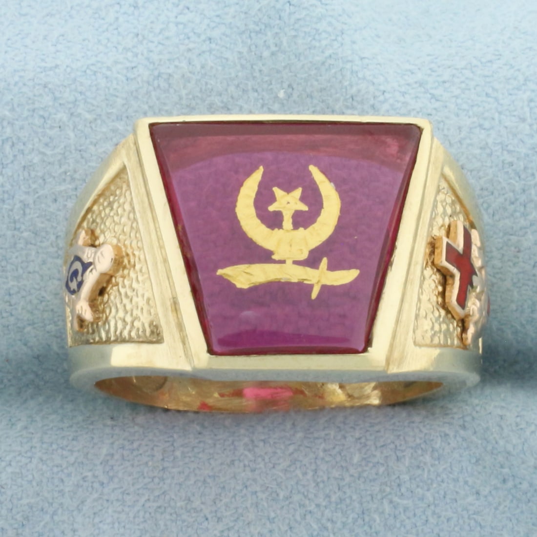 Mens Masonic Shriners Ring in 10k Yellow Gold: In 10k Yellow Gold. 16mm Lab Ruby center stone. 15mm wide. Enamel details. Size 11. 13.5g.