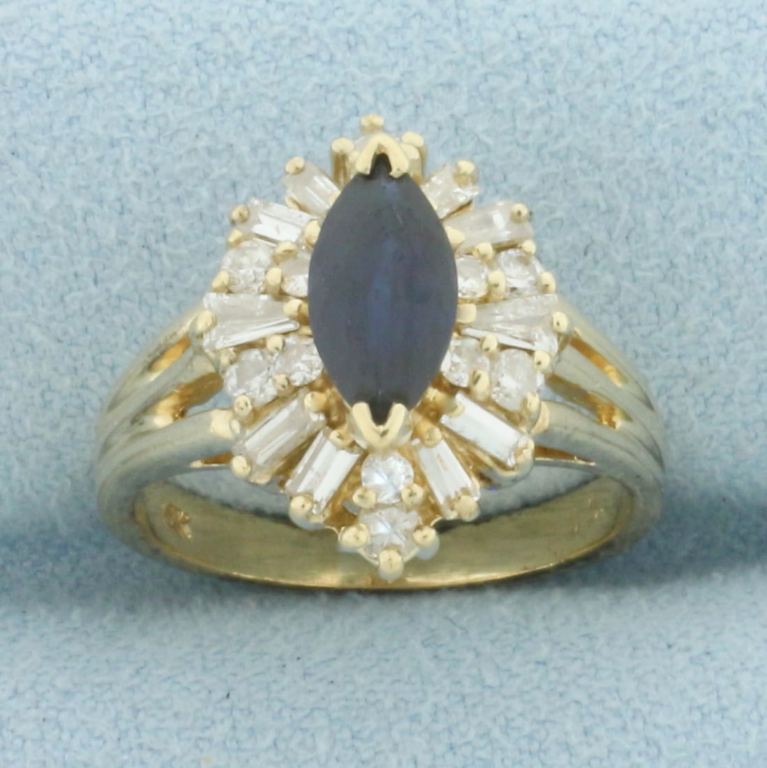 Sapphire and Diamond Halo Ring in 14k Yellow Gold: In 14k Yellow Gold. Contains one high quality 9mm natural Sapphire gemstone, approximately 1ct, with deep color and excellent clarity. Also contains twelve round and ten baguette high quality