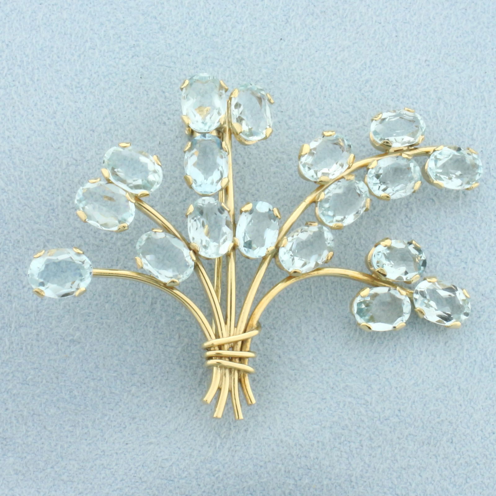 Vintage Aquamarine Flower Bouquet Brooch Pin in 18k Yellow Gold: In 18k Yellow Gold. Contains eighteen 7mm high quality natural oval cut aquamarine gemstones with bright color and excellent clarity. 2 1/8 inch wide. 1 1/2 inch long. 9.1g.
