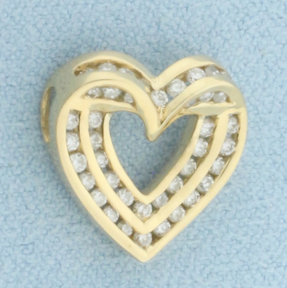 Diamond Heart Pendant in 10k Yellow Gold: In 10k Yellow Gold. Contains forty-one high quality 1/2pt diamonds. 5/8 inch long. 5/8 inch wide. 1.9g.