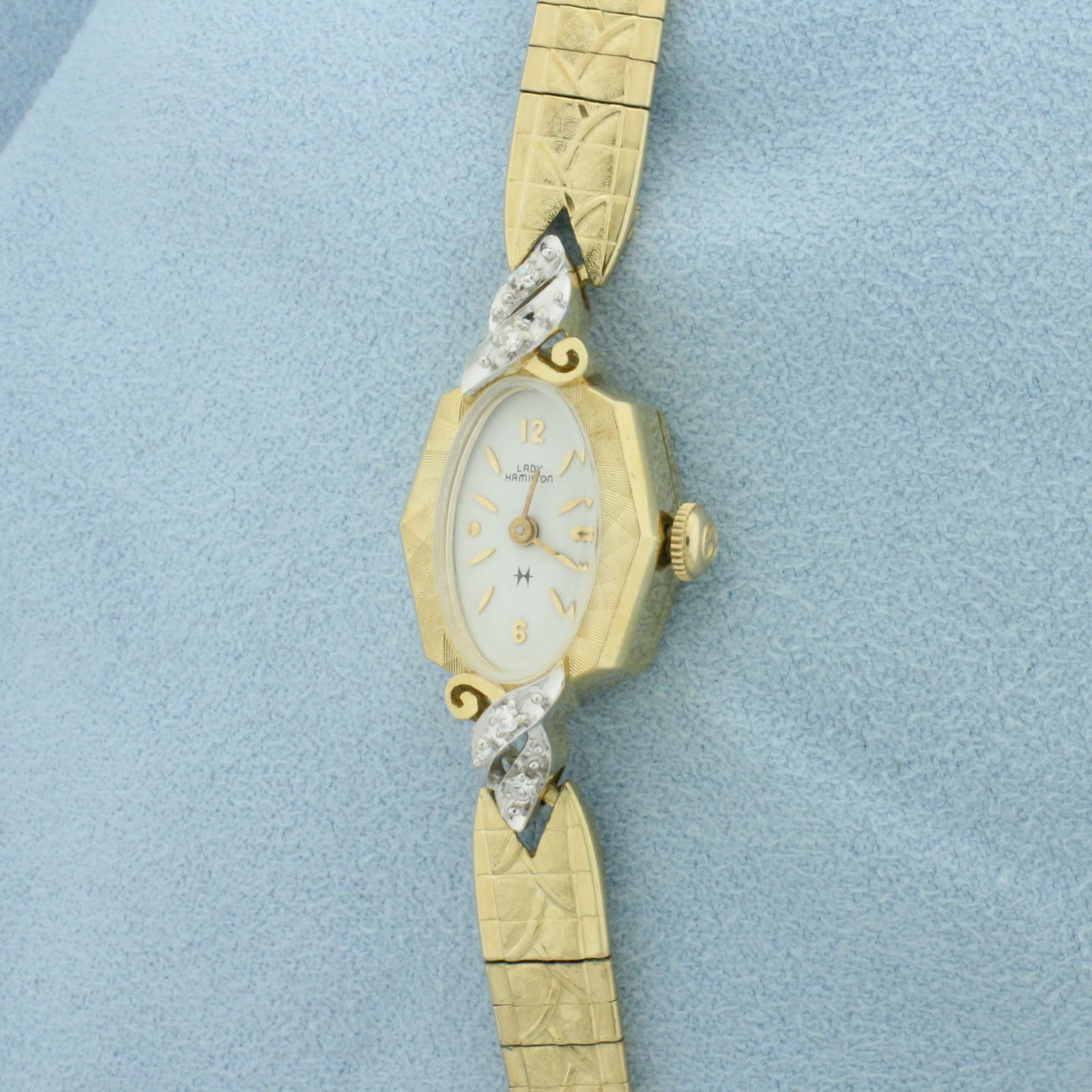 Vintage Ladies Hamilton Diamond Watch in Solid 14k Yellow Gold Case: Solid 14k Yellow Gold Case, Gold Plated Bracelet. Stamped inside case "808665", "73807", "I + W". Mechanical wind movement runs great. Case 19mm long. Contains four high quality .01ct diamonds. Safety