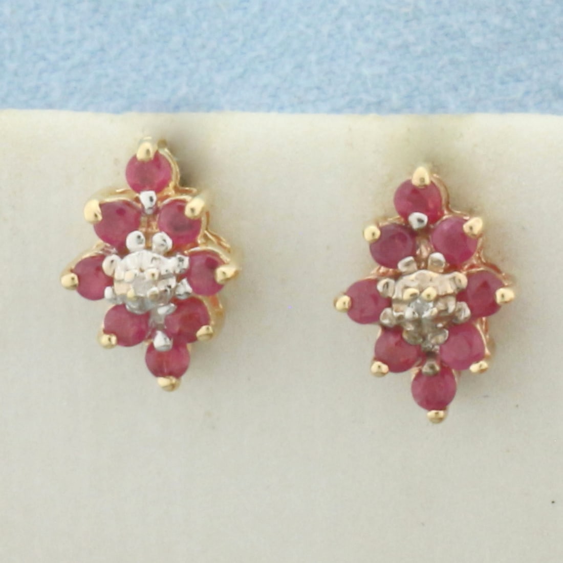 Ruby and Diamond Earrings in 10k Yellow Gold: In 10k Yellow Gold. Contains sixteen 2mm high quality natural Ruby gemstones with bright color. Also contains two high quality 1/2pt diamonds. 3/8 inch long. 1/4 inchwide. Friction backs. 1.4g.