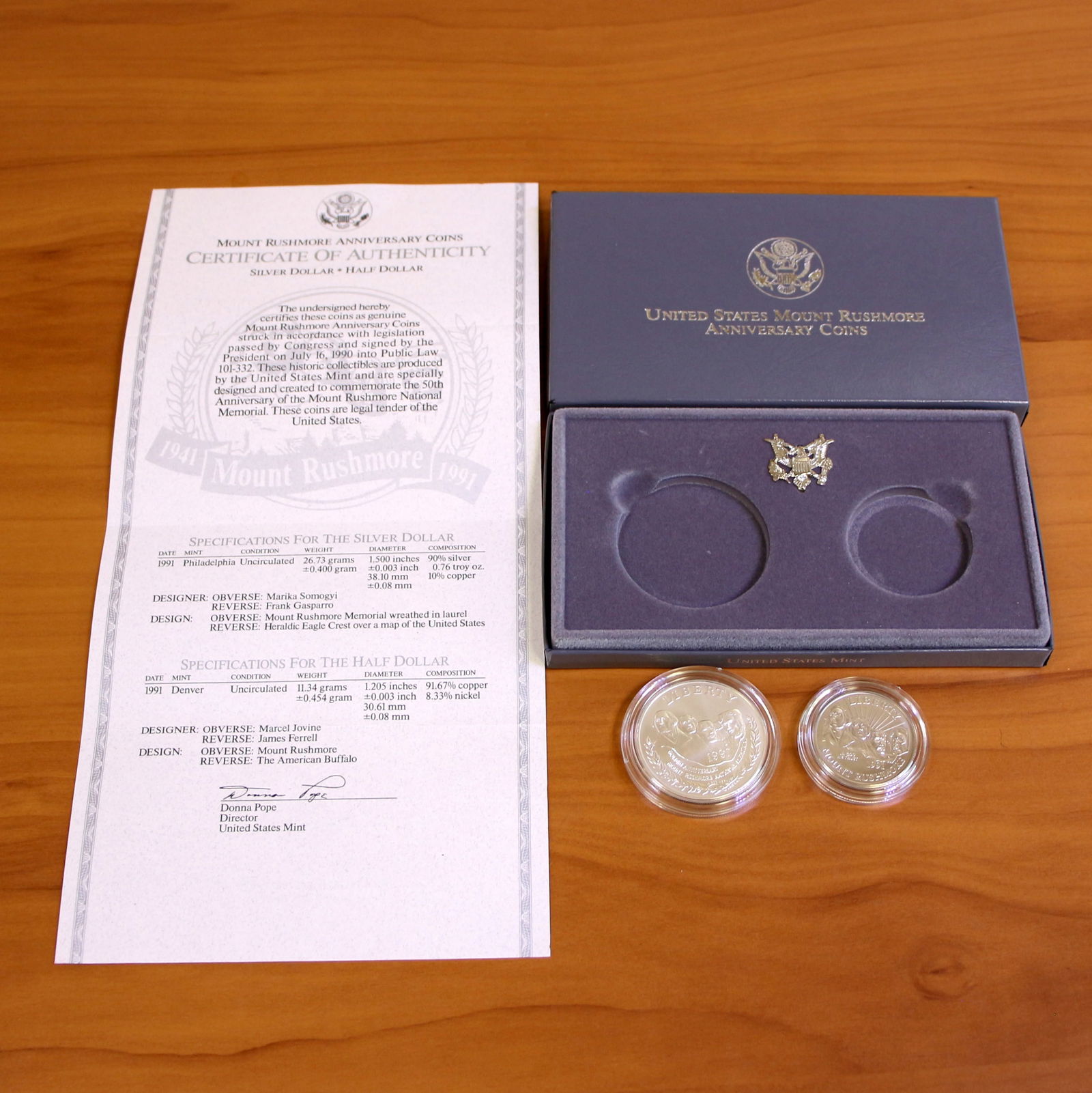 US Mint Mount Rushmore Anniversary Silver Coin Set OGP: Contains one 1991 90% Silver Uncirculated Mount Rushmore Anniversary Silver Dollar. Also contains one 1991 Uncirculated Mount Rushmore Anniversary Half Dollar. Set in original government packaging and