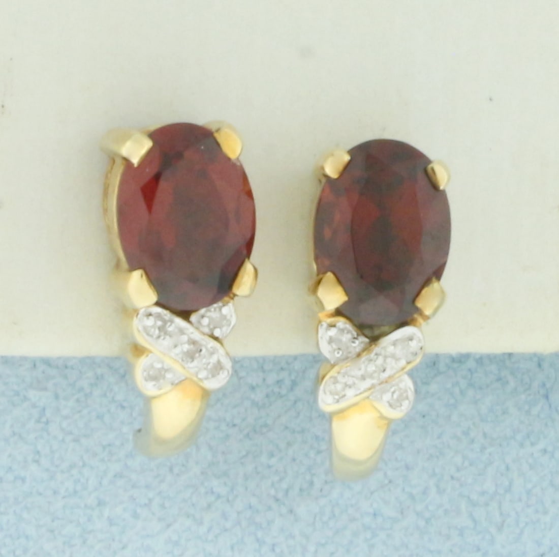 Vintage Garnet and Diamond Earrings in 10k Yellow Gold: In 10k Yellow Gold. Contains two 8x6mm high quality natural Garnet gemstones, approximately 3ct TW, with deep color and excellent clarity. Also contains ten 1/2pt high quality diamonds. 1/2 inch long.