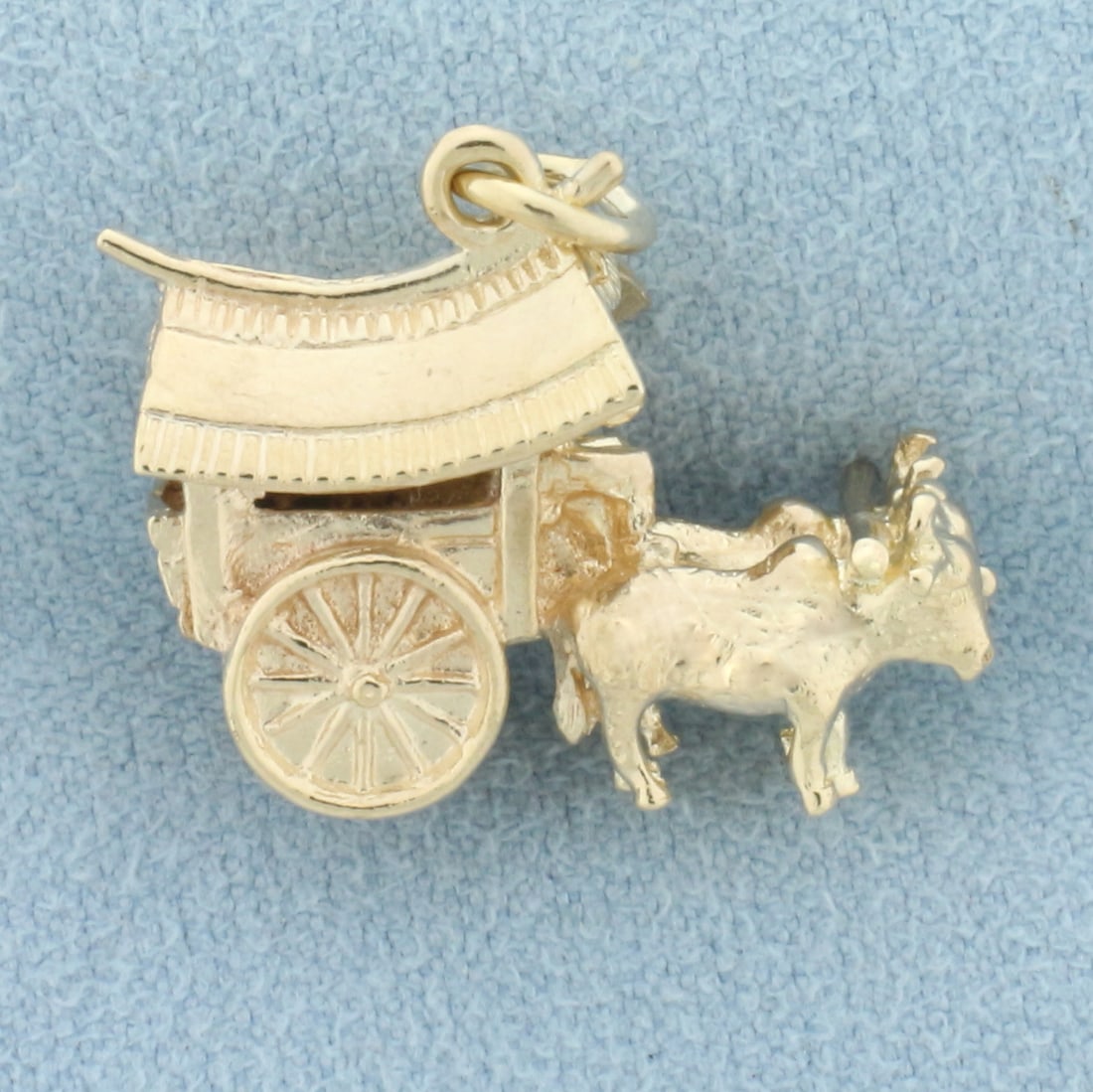 Japanese Ox Cart Charm in 9k Yellow Gold: In 9k yellow gold. 3D design. 7/8 inch long (including jump ring) by 7/8 inch wide. 5.2g.