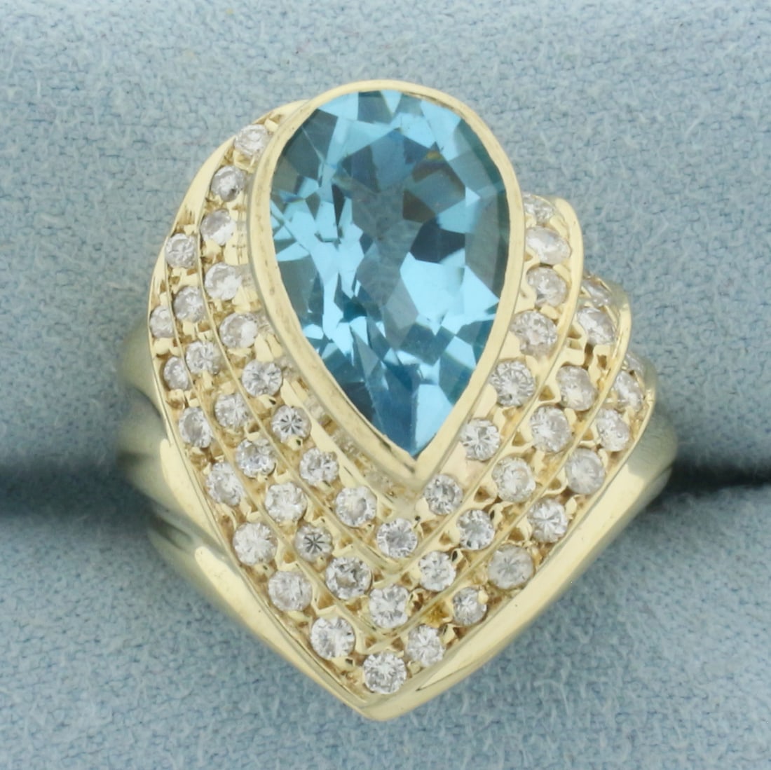 Swiss Blue Topaz and Diamond Statement Ring in 14k Yellow Gold: In 14k Yellow Gold. Contains one high quality natural 5ct Swiss Blue Topaz gemstone with electric blue color and excellent clarity. Also contains fifty-three high quality diamonds, 1ct TW, SI
