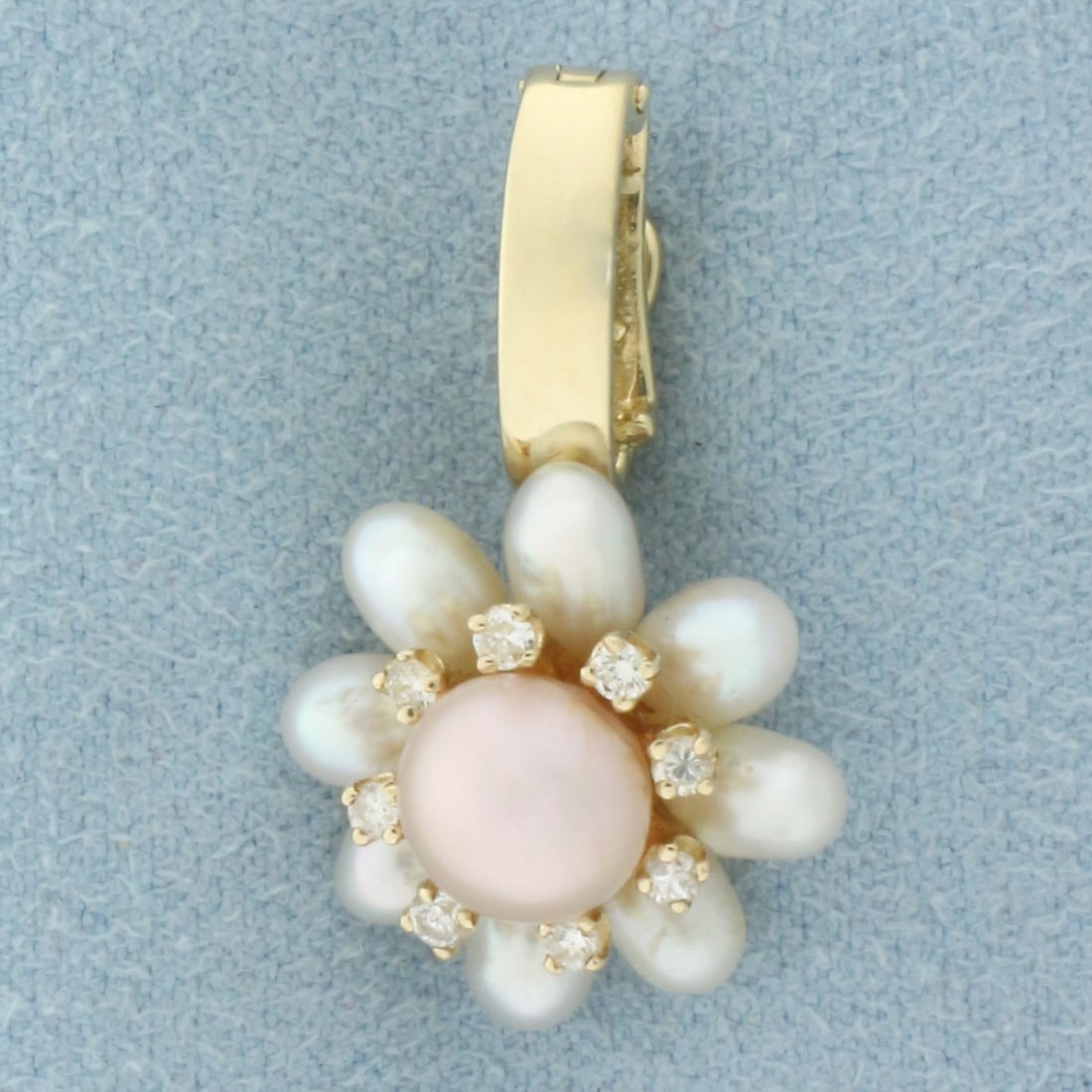 Akoya Pearl and Diamond Pendant in 14k Yellow Gold: In 14k Yellow Gold. Contains one 7mm high quality cultured Akoya Pearl with pink undertone and high luster. Also contains eight 5.5mm high quality Akoya pearls with white undertone and high luster. Al