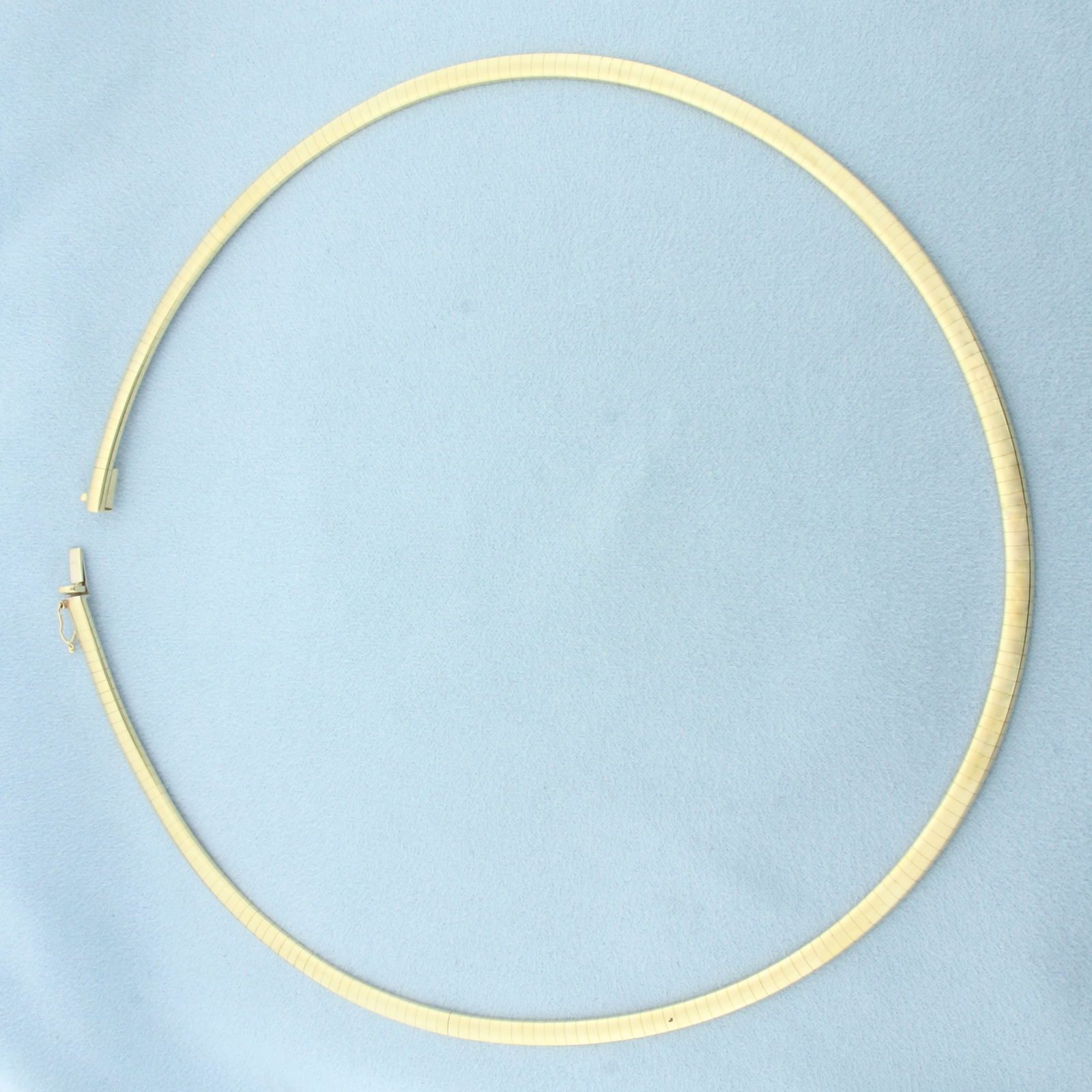 18 Inch Italian Omega Necklace in 14k Yellow Gold: In 14k Yellow Gold. 18 inches long. 4.2mm wide. Italian made. Concealed slide clasp with safety latch. 29.0g.