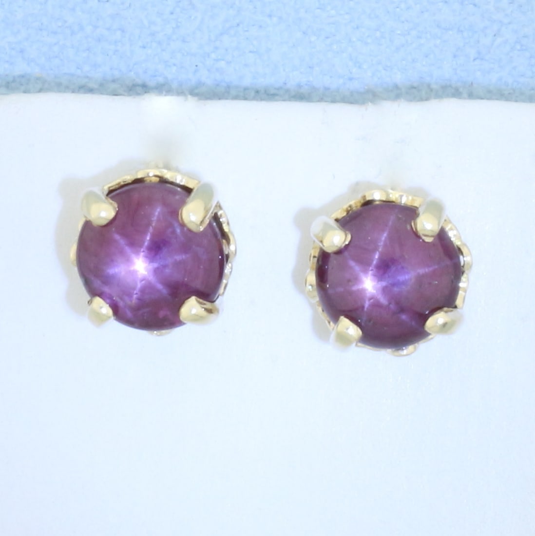 Natural Star Ruby Stud Earrings 14k Yellow Gold: In 14k yellow gold. Each earring contains one 7mm high quality natural Star Ruby with very distinctive "star" under light. Approximately 4ct TW. Friction backs. 2.7g.