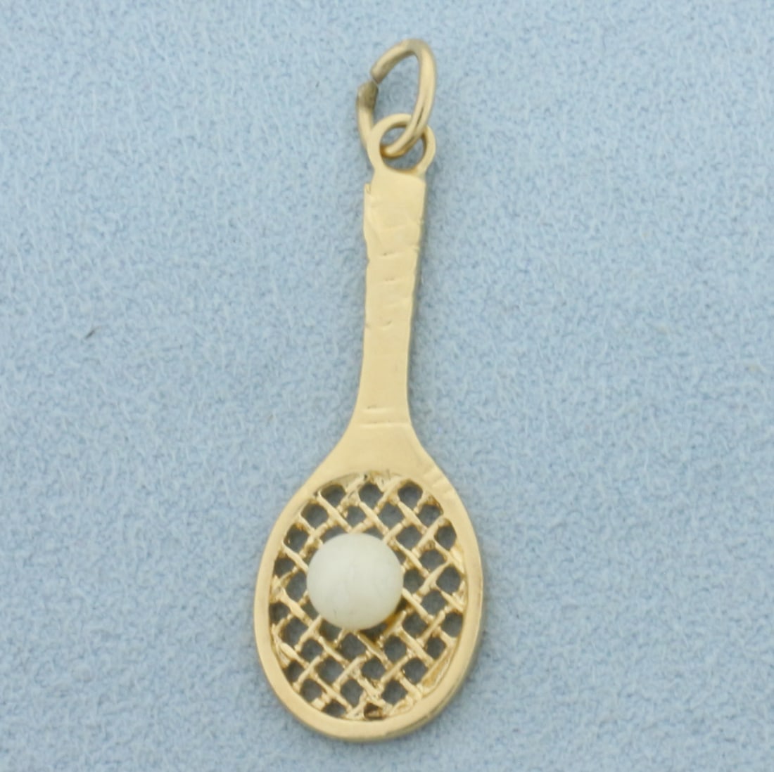 Tennis Racket Pearl Charm in 14k Yellow Gold: In 14k Yellow Gold. Contains one 4mm cultured pearl. 1 1/2 inch long including jump ring. 1/2 inch wide at widest. 2.2g.