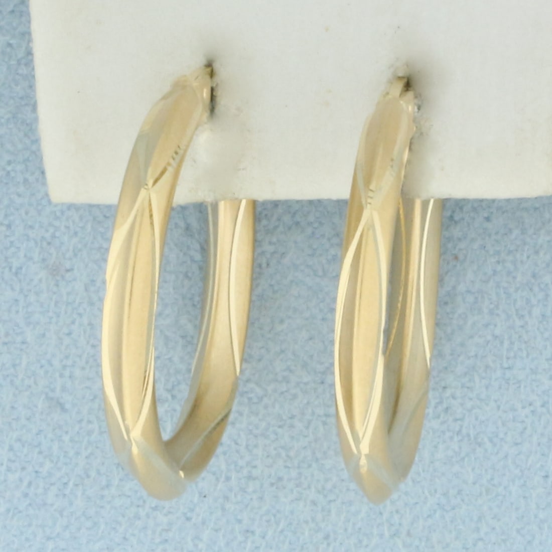 Diamond Cut Matte Finish Hoop Earrings in 14k Yellow Gold: In 14k Yellow Gold. 1 inch long. 3mm wide. Leverback. 2.1g.