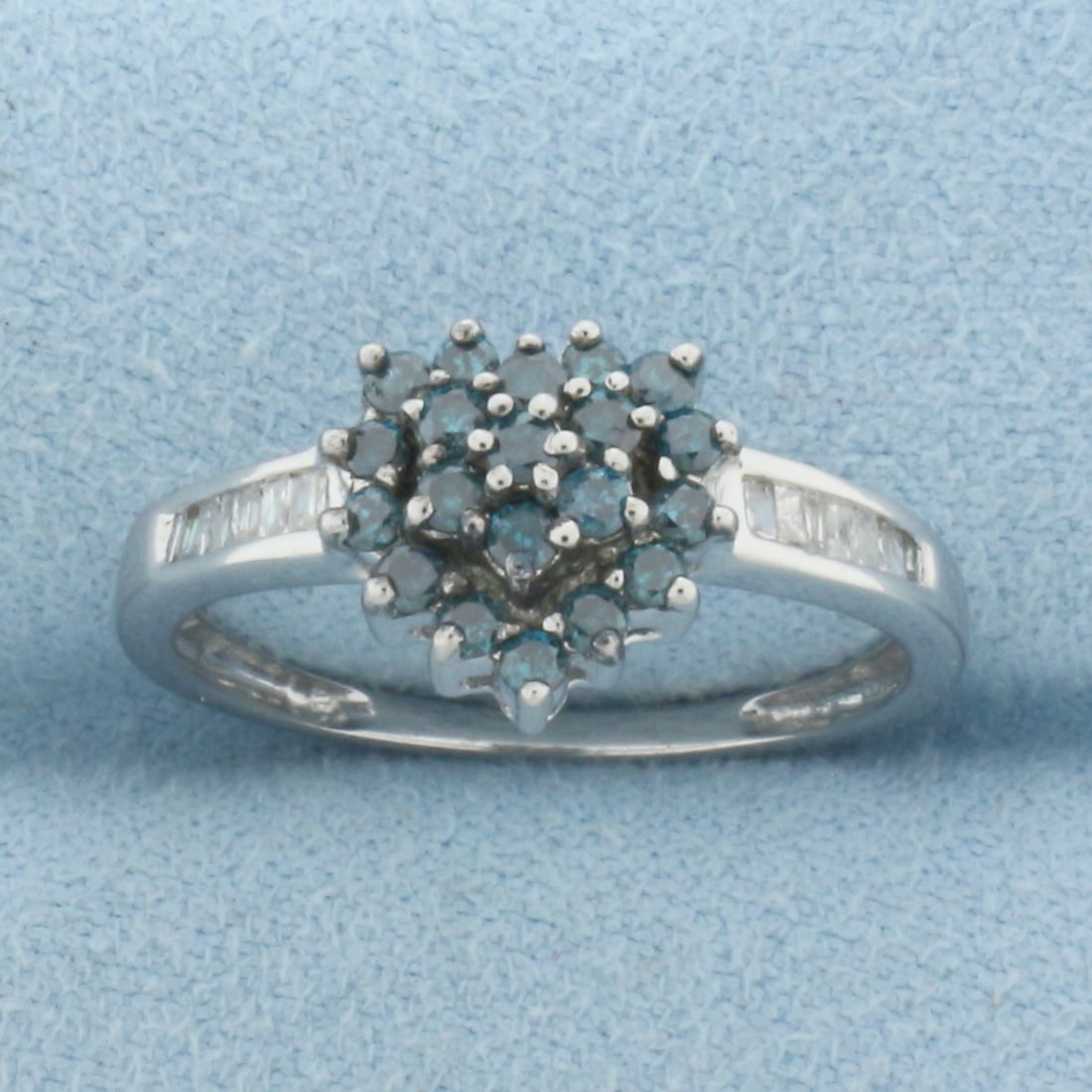 Blue and White Diamond Heart Ring in 10k White Gold: In 10k White Gold. Contains twenty round blue diamonds and fourteen white baguette high quality diamonds, 1/2ct TW. 10mm wide spread at top of ring. Size 8.25. 2.3g.