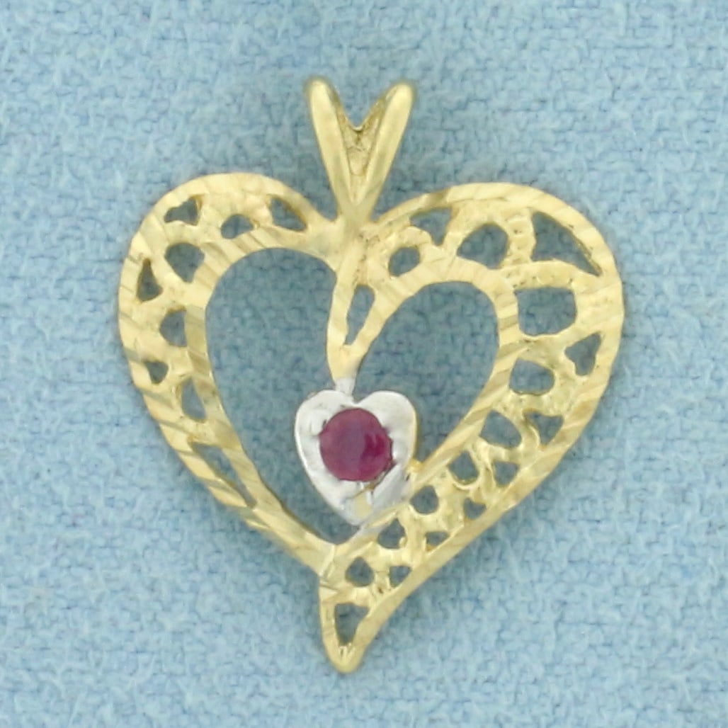 Ruby Heart Pendant in 10k Yellow Gold: In 10k Yellow Gold. Contains one 2mm high quality natural Ruby gemstone with intense color. 3/4 inch long. 5/8 inch wide. .6g.