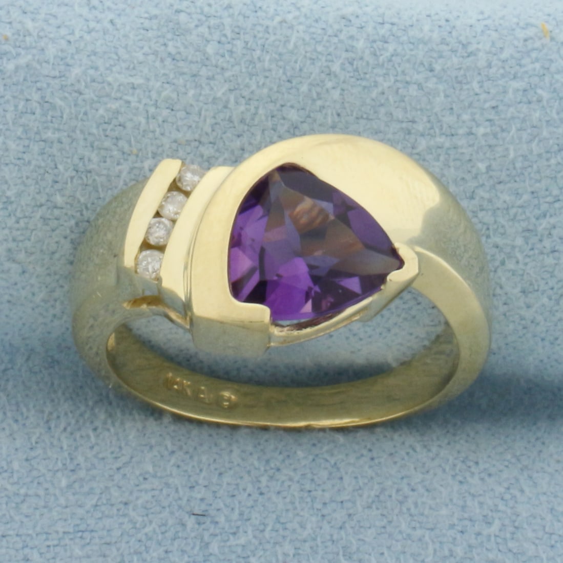 Amethyst and Diamond Ring in 14k Yellow Gold: In 14k Yellow Gold. Contains one 8mm high quality trillion cut natural Amethyst gemstone, approximately 1ct, with intense color and excellent quality. Also contains four high quality .01ct diamond.