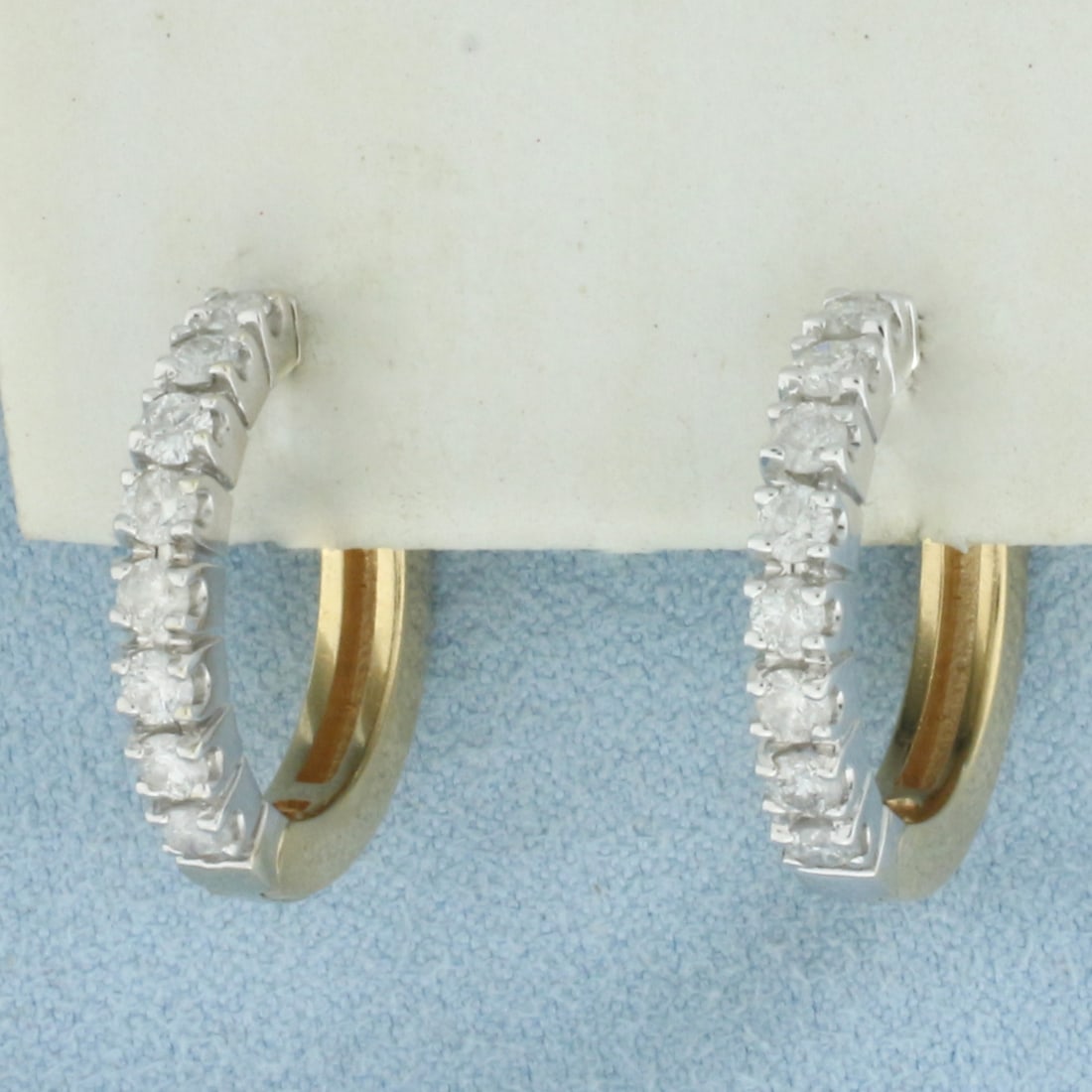 Diamond Two Tone Hoop Earrings in 14k Yellow Gold: In 14k Yellow Gold. Contains sixteen high quality diamonds, 1ct TW, H color/I clarity. 3/4 inch long. 3/4 inch wide. Hinged locking closure. 7.5g.