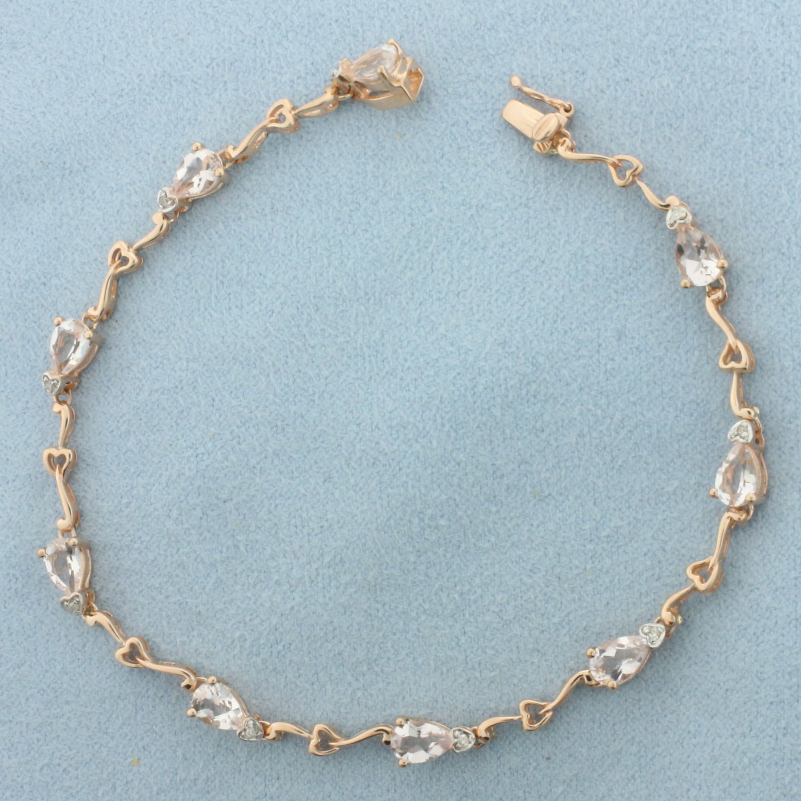 Morganite and Diamond Heart Bracelet in 10k Rose Gold: In 10k Rose Gold. Contains nine 4x6mm high quality Morganite gemstones with excellent clarity. Also contains nine high quality 1/2pt diamonds. 7.5 inches long. 4.6mm wide. Concealed slide clasp with