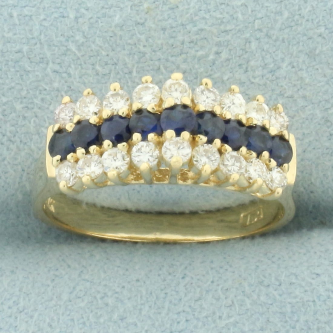 Sapphire and Diamond Cathedral Line Ring in 14k Yellow Gold: In 14k yellow gold. Contains nine high quality natural AA quality 2.5mm Saphire gemstones with vibrant color and excellent clarity. Also contains eighteen high quality .03ct diamonds, SI clarity/H col