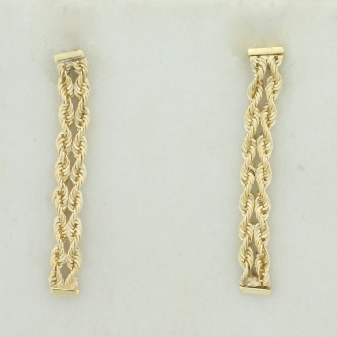 Twisting Rope Link Dangle Earrings in 14k Yellow Gold: In 14k Yellow Gold. 1 inch long. 3mm wide. Friction backs. 1.1g.