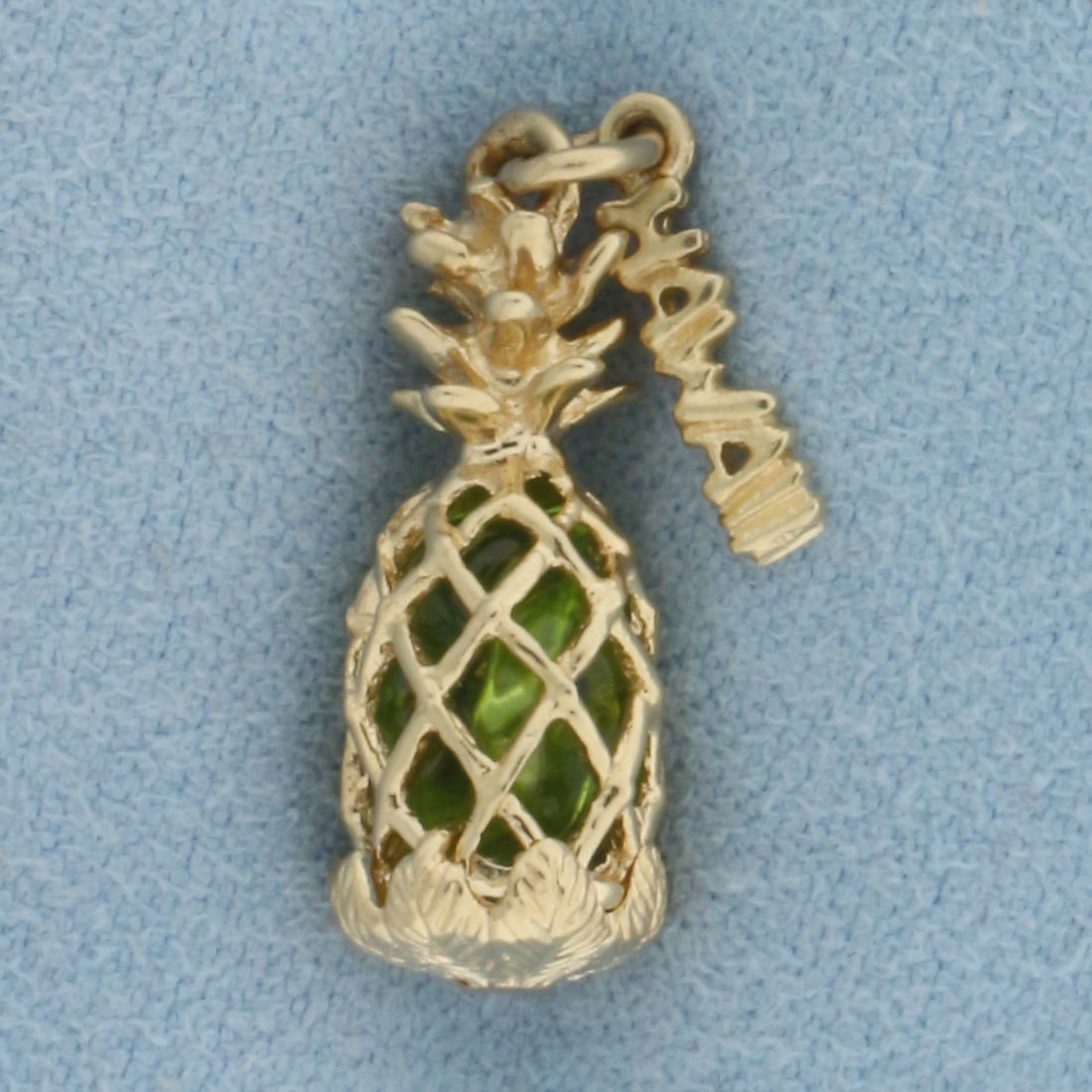 Hawaii Pineapple Peridot Charm in 14k Yellow Gold: In 14k Yellow Gold. Contains high quality natural Peridot gemstones with vibrant color in center. 7/8 inch long (including jump ring). 3/8 inch wide. 3.0g.