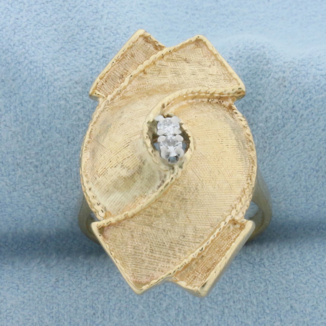 Diamond Ribbon Design Ring in 14k Yellow Gold: In 14k Yellow Gold. Contains two high quality .04ct diamonds, VS clarity/G color. 1 1/8 inches wide at top of ring. Size 9. 9.1g.