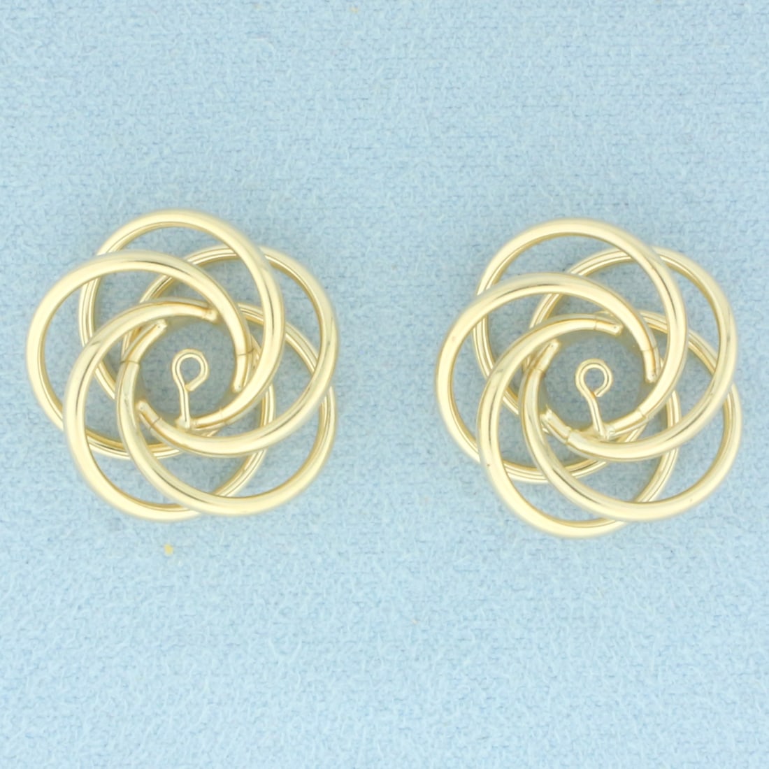 Knot Design Stud Earring Jacket Enhancers in 14k Yellow Gold: In 14k Yellow Gold. 3/4 inch diameter. Designed to fit around stud earrings to give a fresh new look. 3.2g.