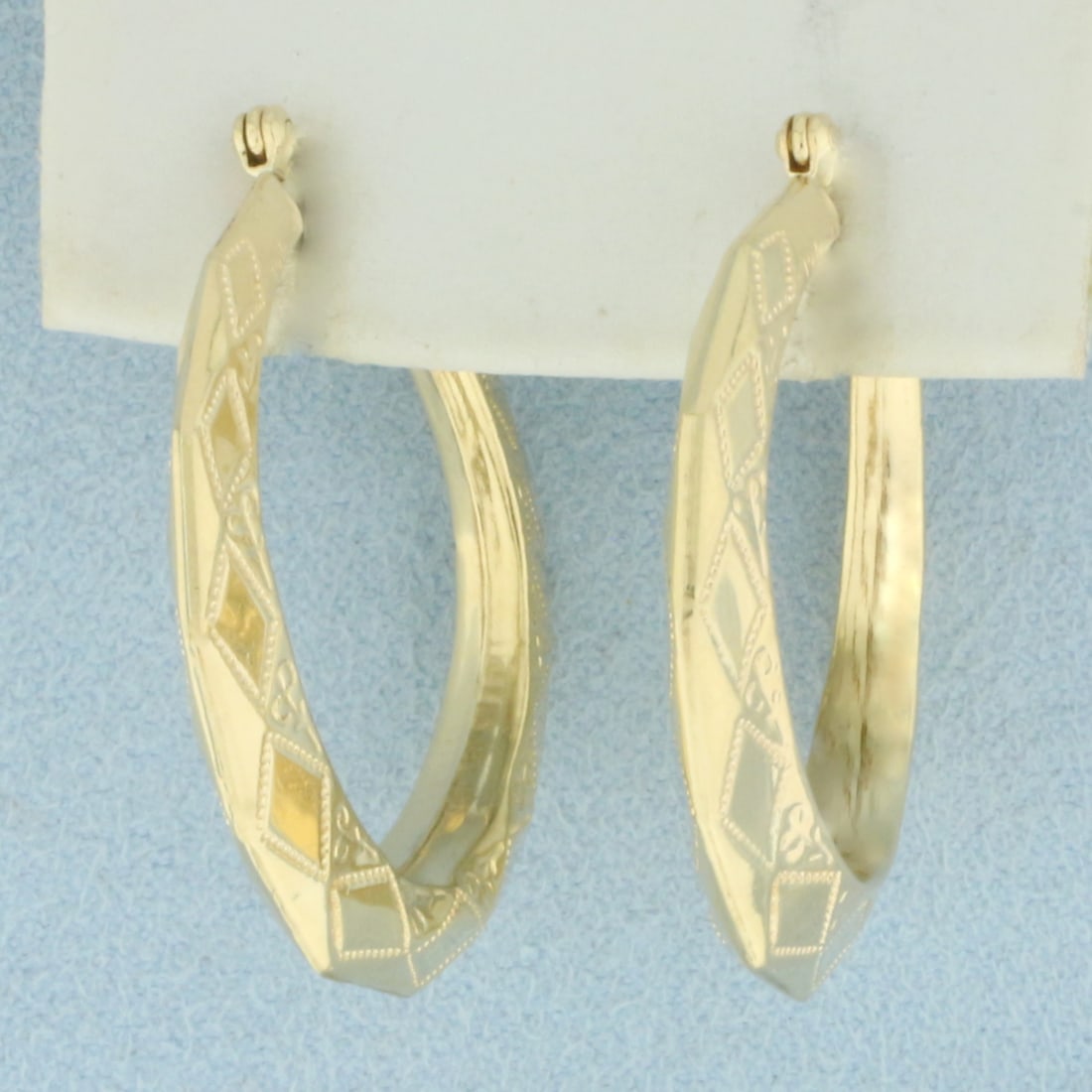 Diamond Etched Hoop Earrings in 14k Yellow Gold: In 14k Yellow Gold. 1 1/4 inches long. Etched diamond pattern. 3.1g.