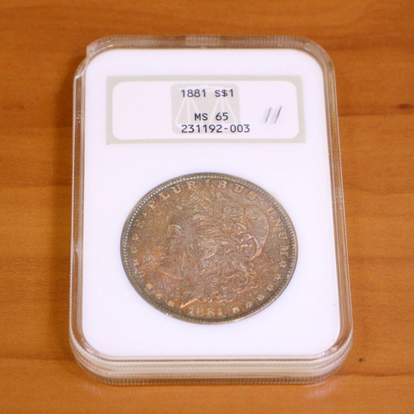 NGC 1881-S MS65 Morgan Silver Dollar Coin: Contains one 1881-S MS65 Morgan Silver Dollar. Packaged by NGC.